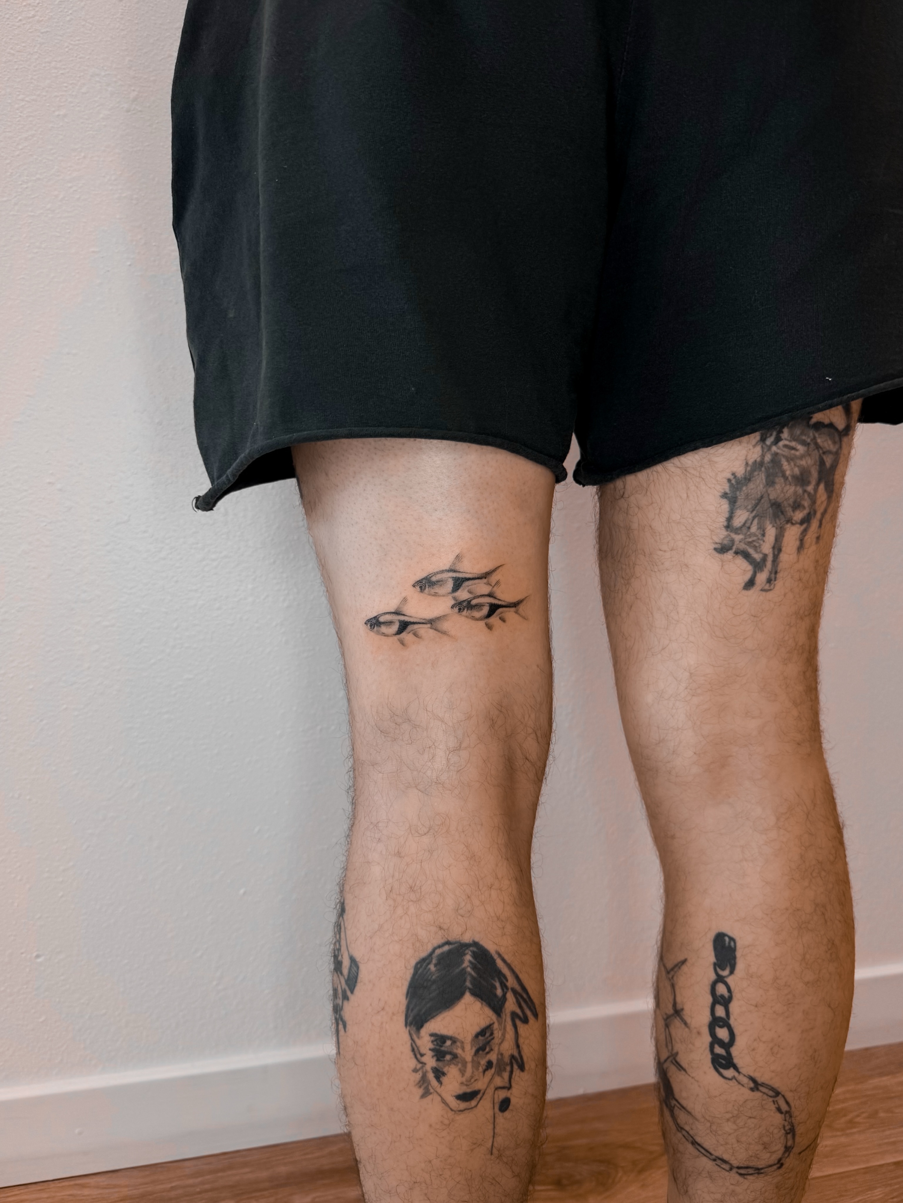 Fishes and woman black and grey tattoo on the leg by Rylee