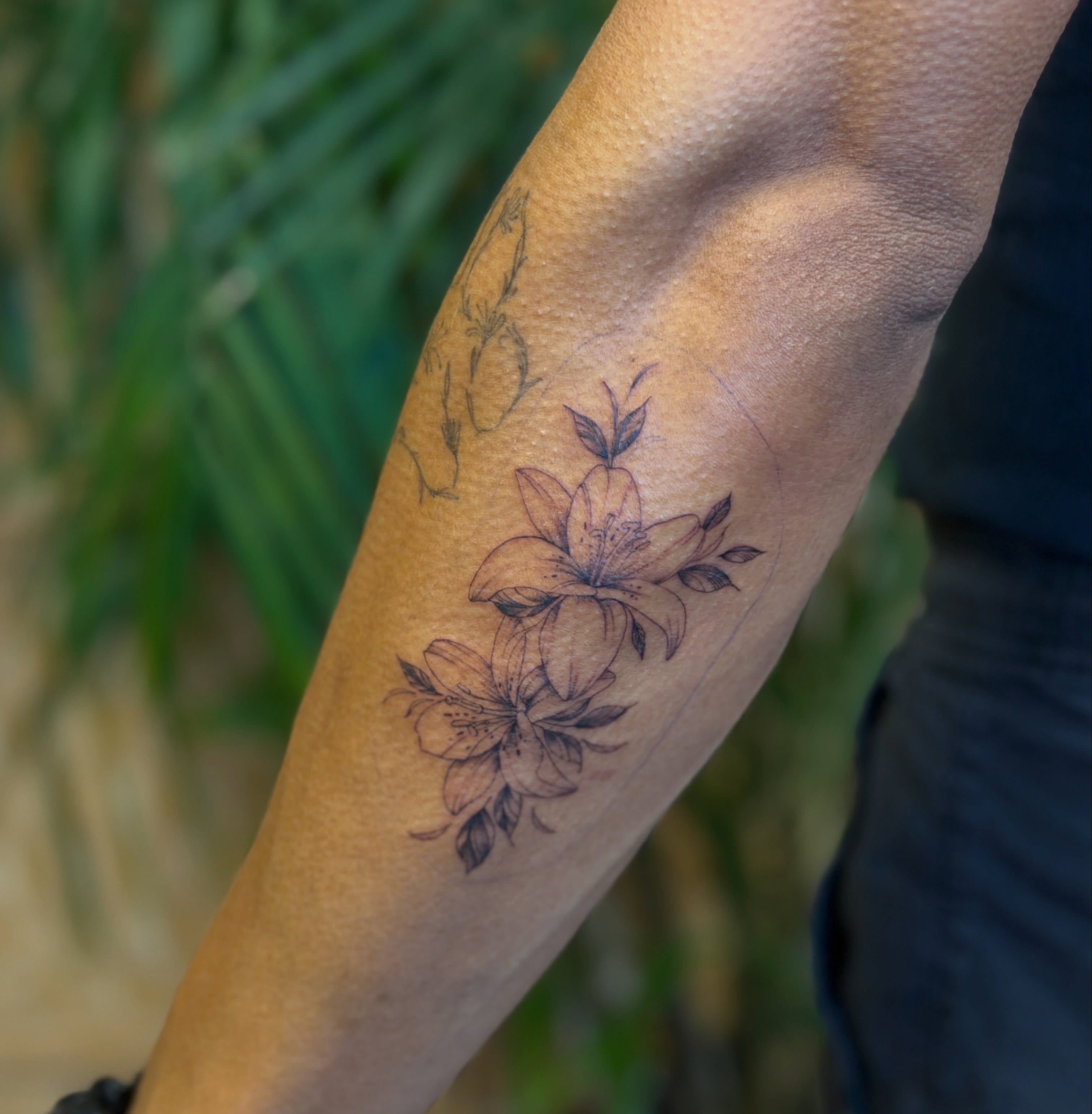Lilies black and grey tattoo on the forearm by Fabian💉 Tattoo artist