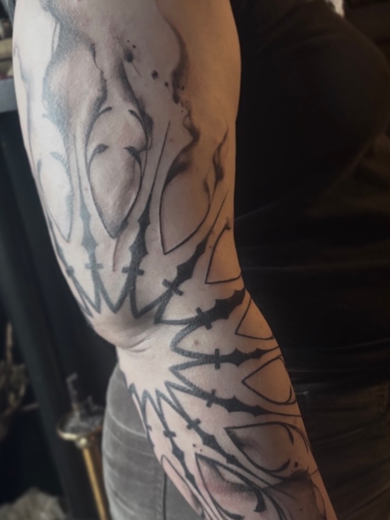 Abstract design black and grey tattoo on the forearm by Cassandra Colleen