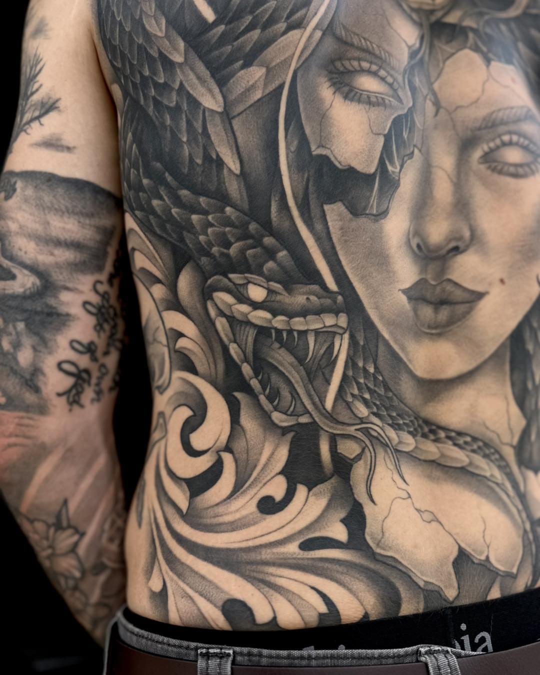 Woman with snake realism tattoo on the torso by Madison Orchard Tattoos