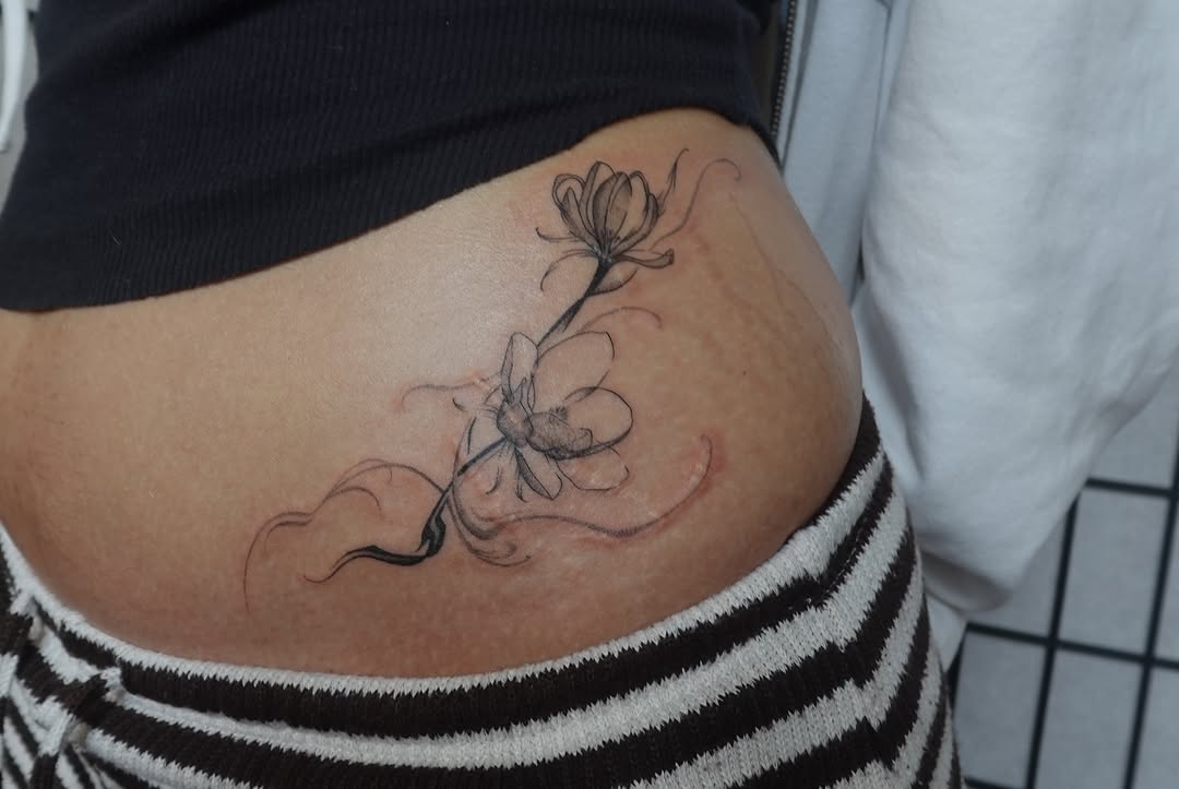 Flowers black and grey tattoo on the thigh by jun
