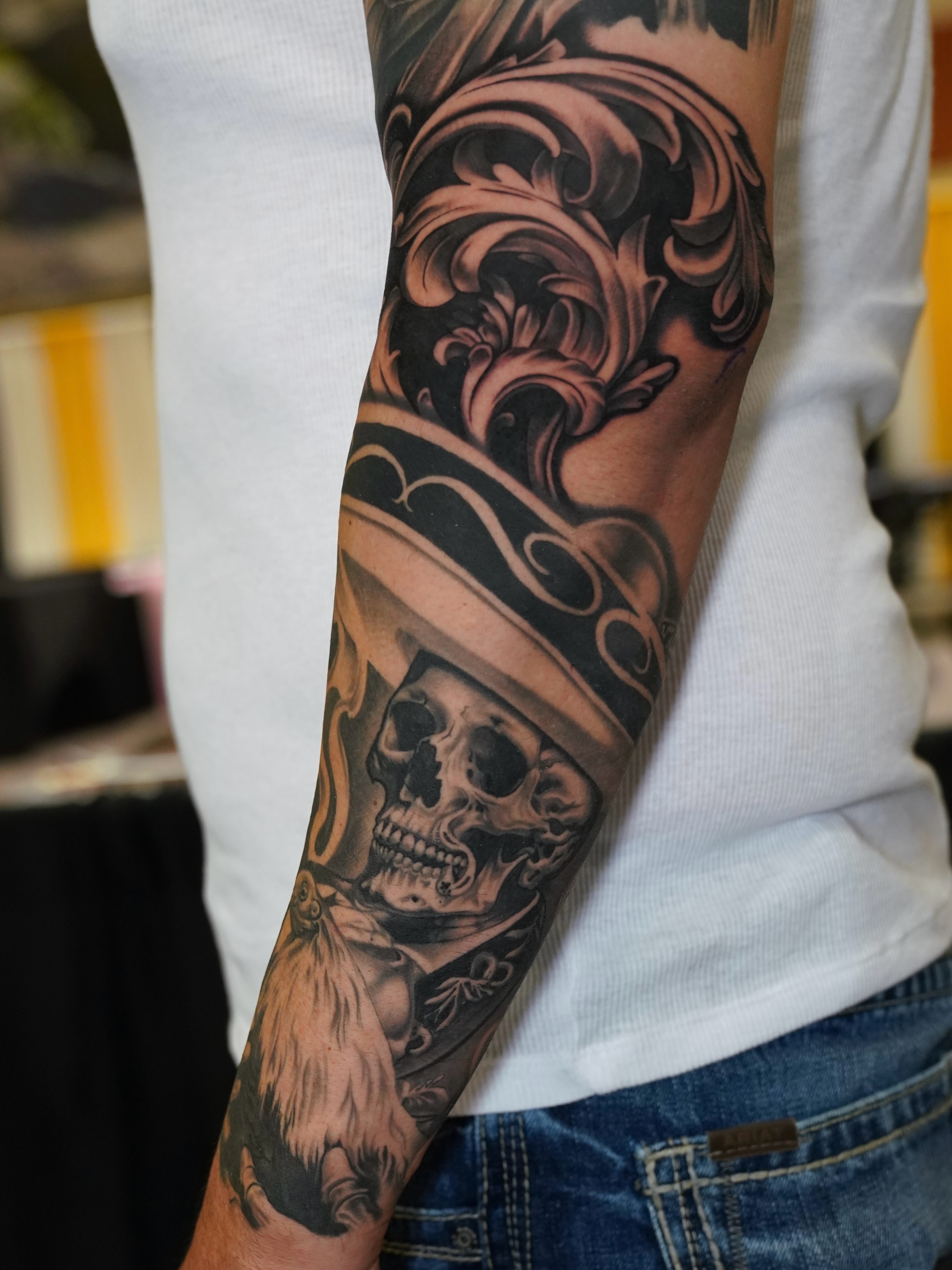 Skull wearing hat realism tattoo on the forearm by Gabriel Quintana “Q”