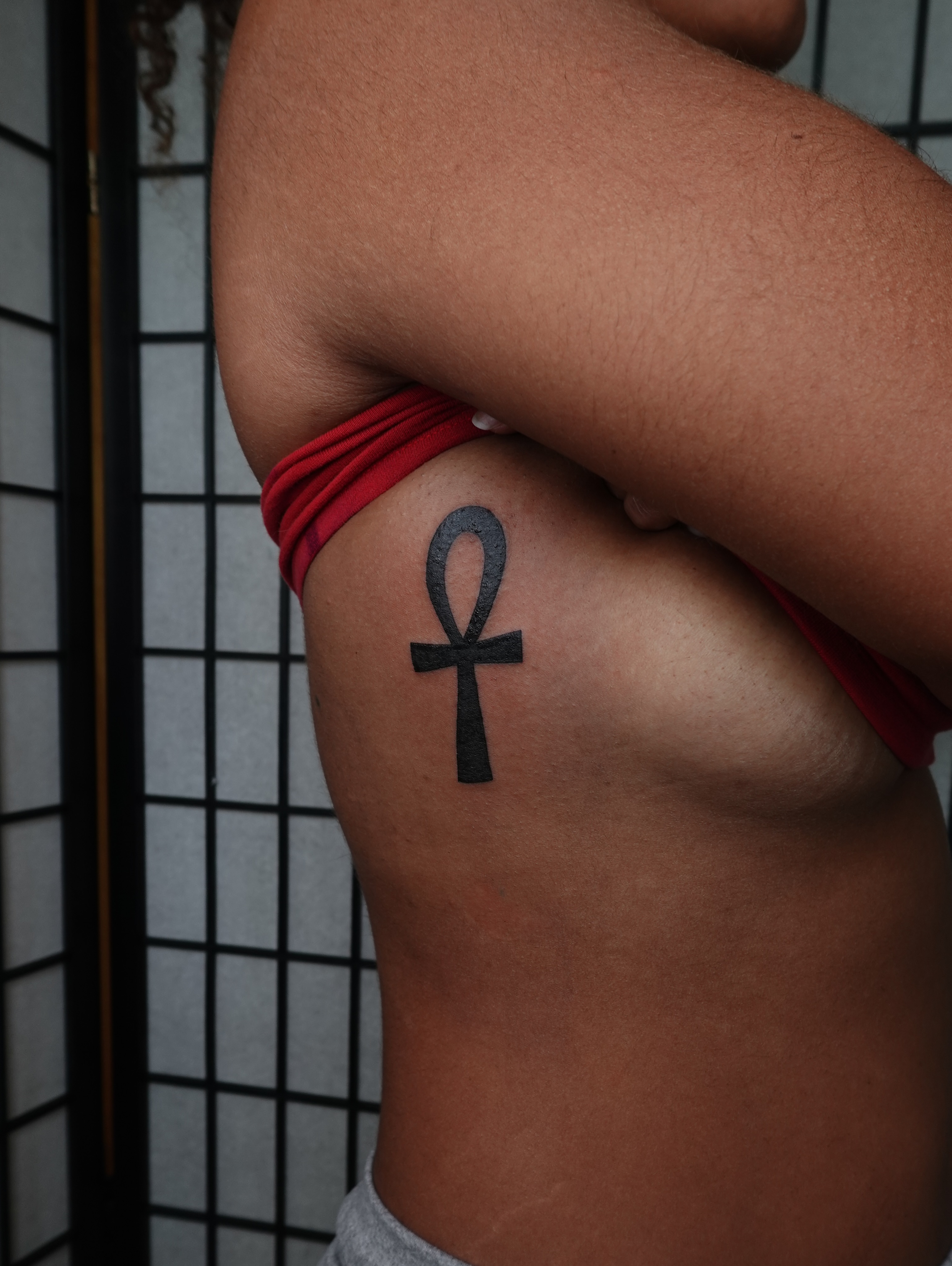 Ankh symbol black and grey tattoo on the ribs by jun