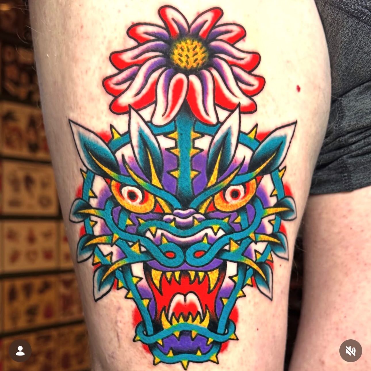 Dragon head with flower American traditional tattoo on the thigh by Kiki Painmaker Trad Tattooer 🧨