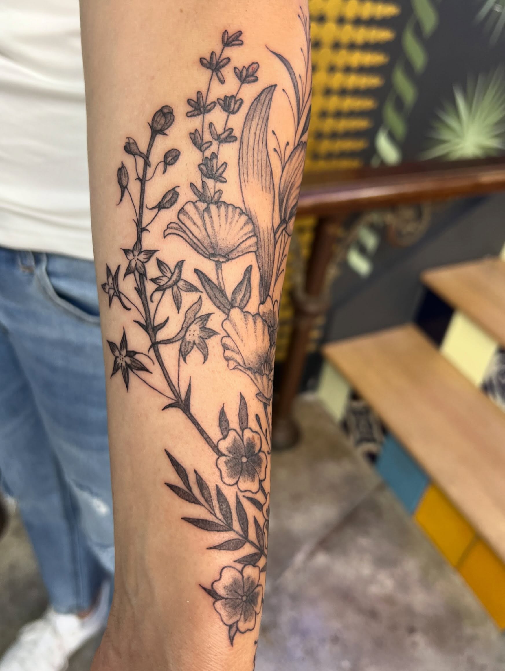 Botanical flowers black and grey tattoo on the forearm by Natalie Phillips, Oakland, California