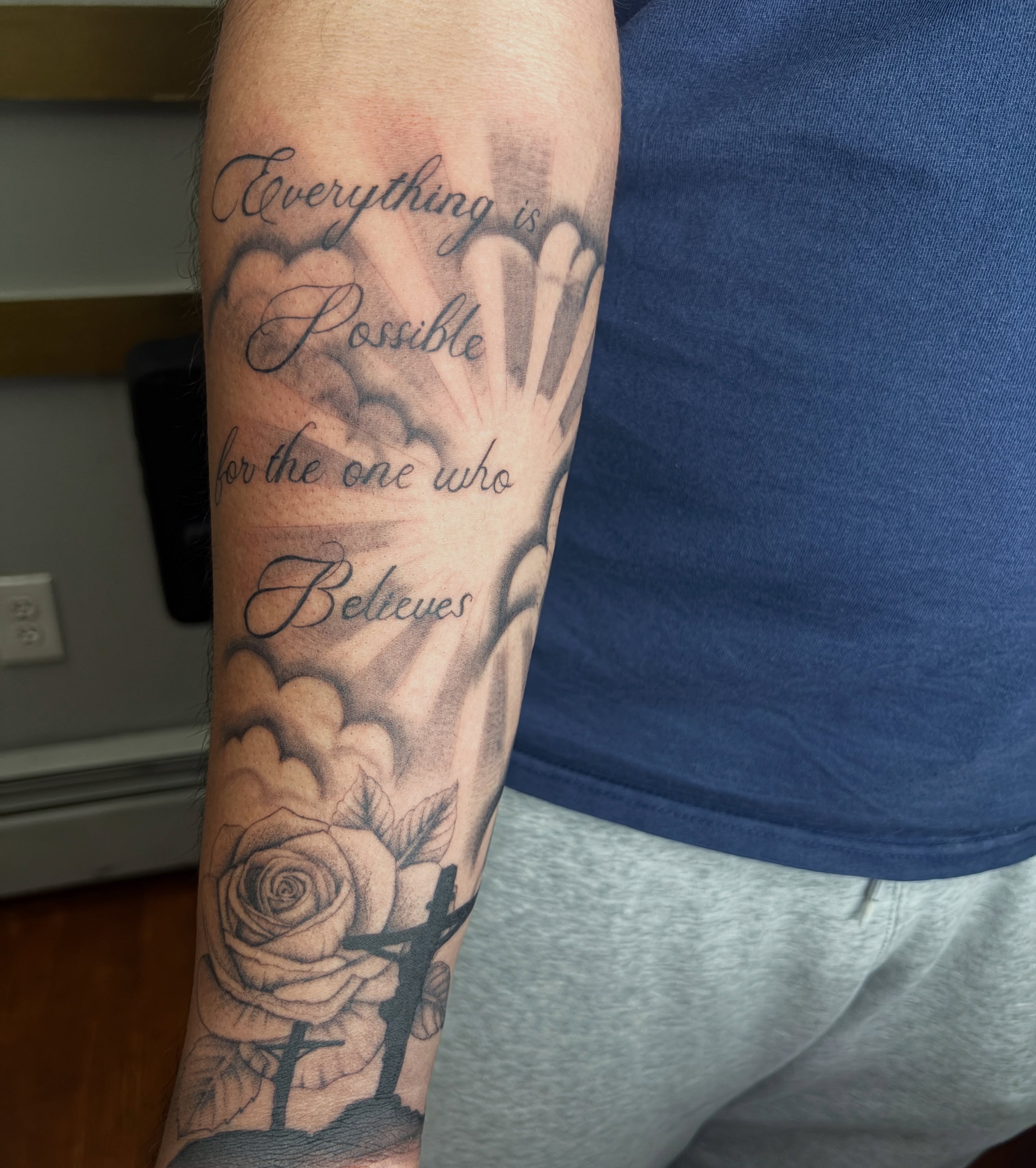 Rose and inspirational quote black and grey tattoo on the forearm by Destineé