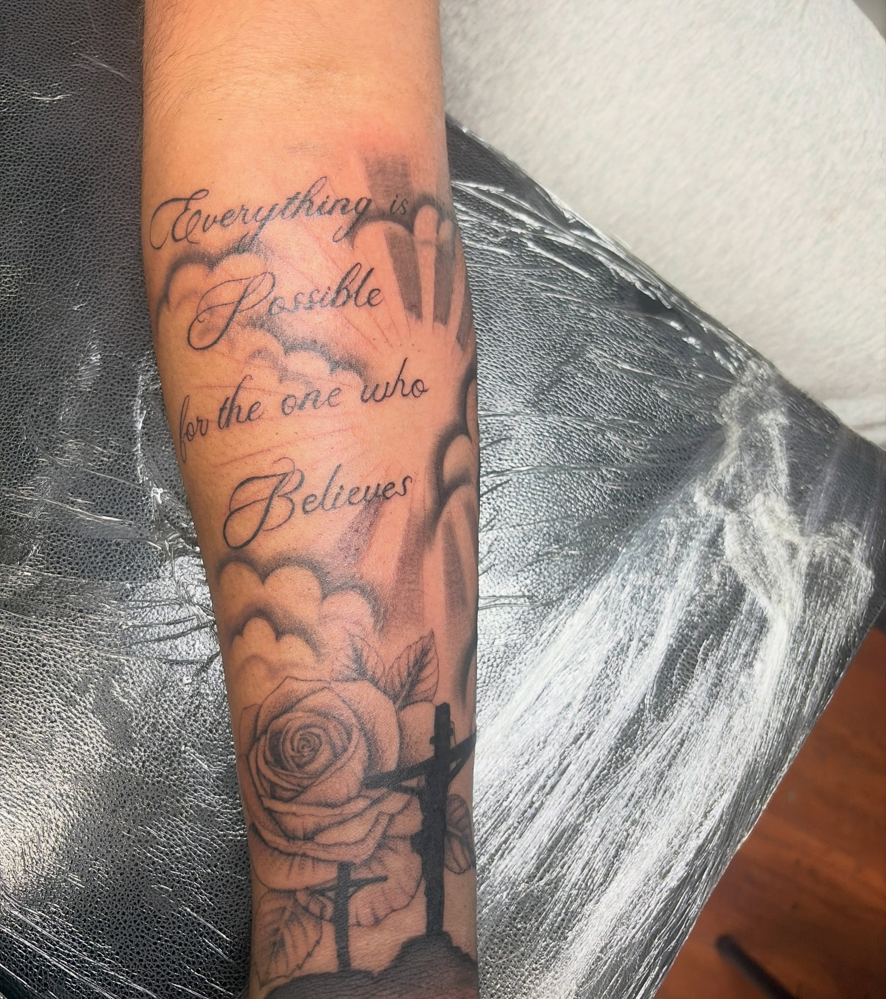 Rose and cross black and grey tattoo on the forearm by Destineé