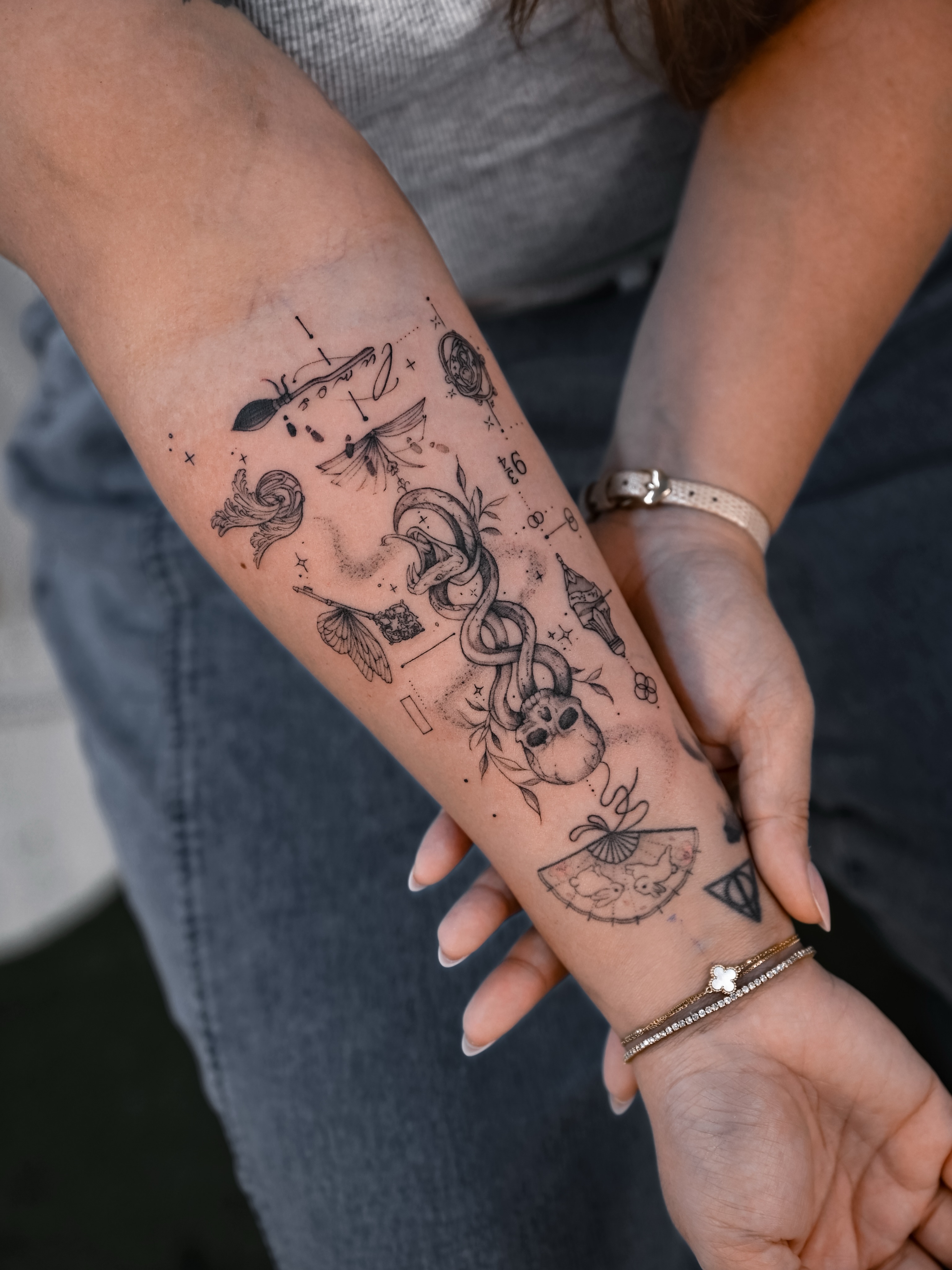 Mythical creatures and symbols black and grey tattoo on the forearm by Kimi