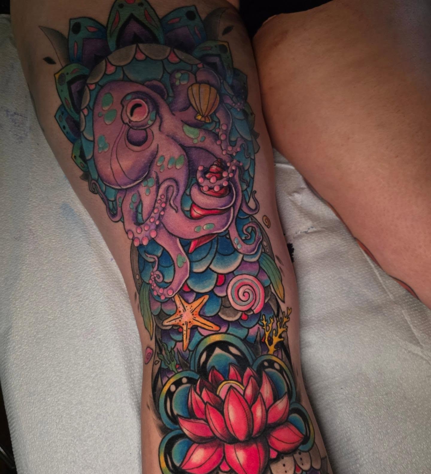 Octopus and lotus new school tattoo on the thigh by Kayla Williams