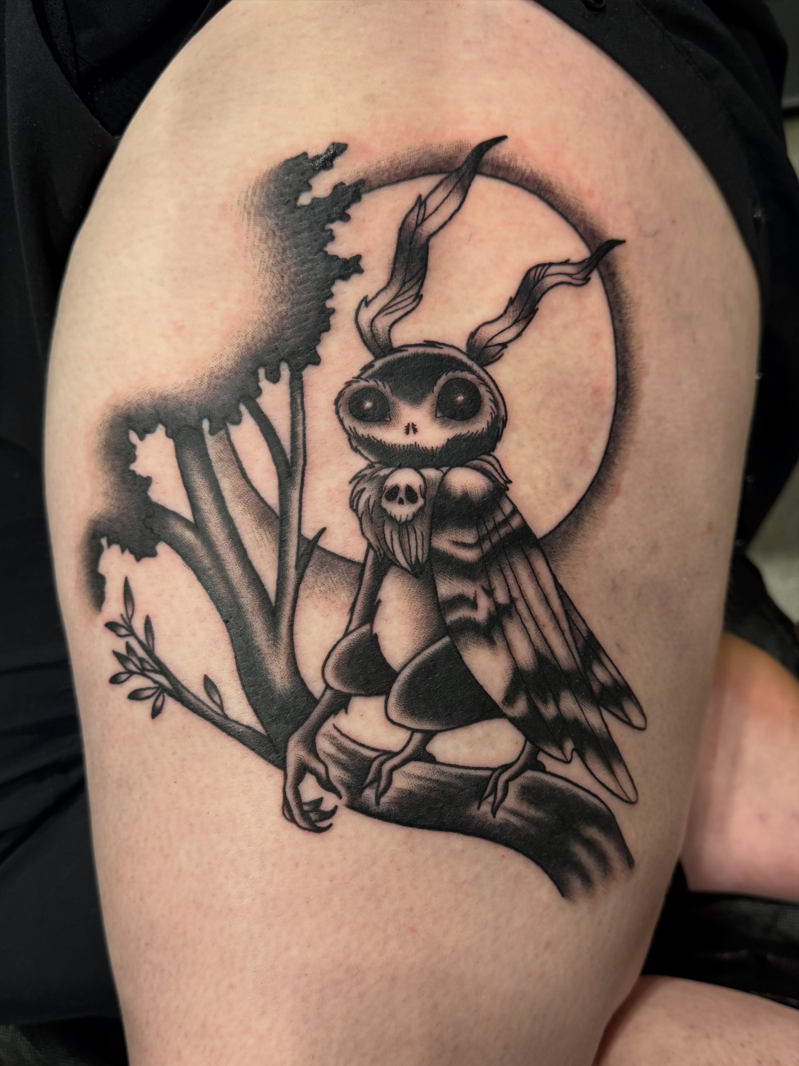 Owl-like creature black and grey tattoo on the shoulder by Emily Lestrange