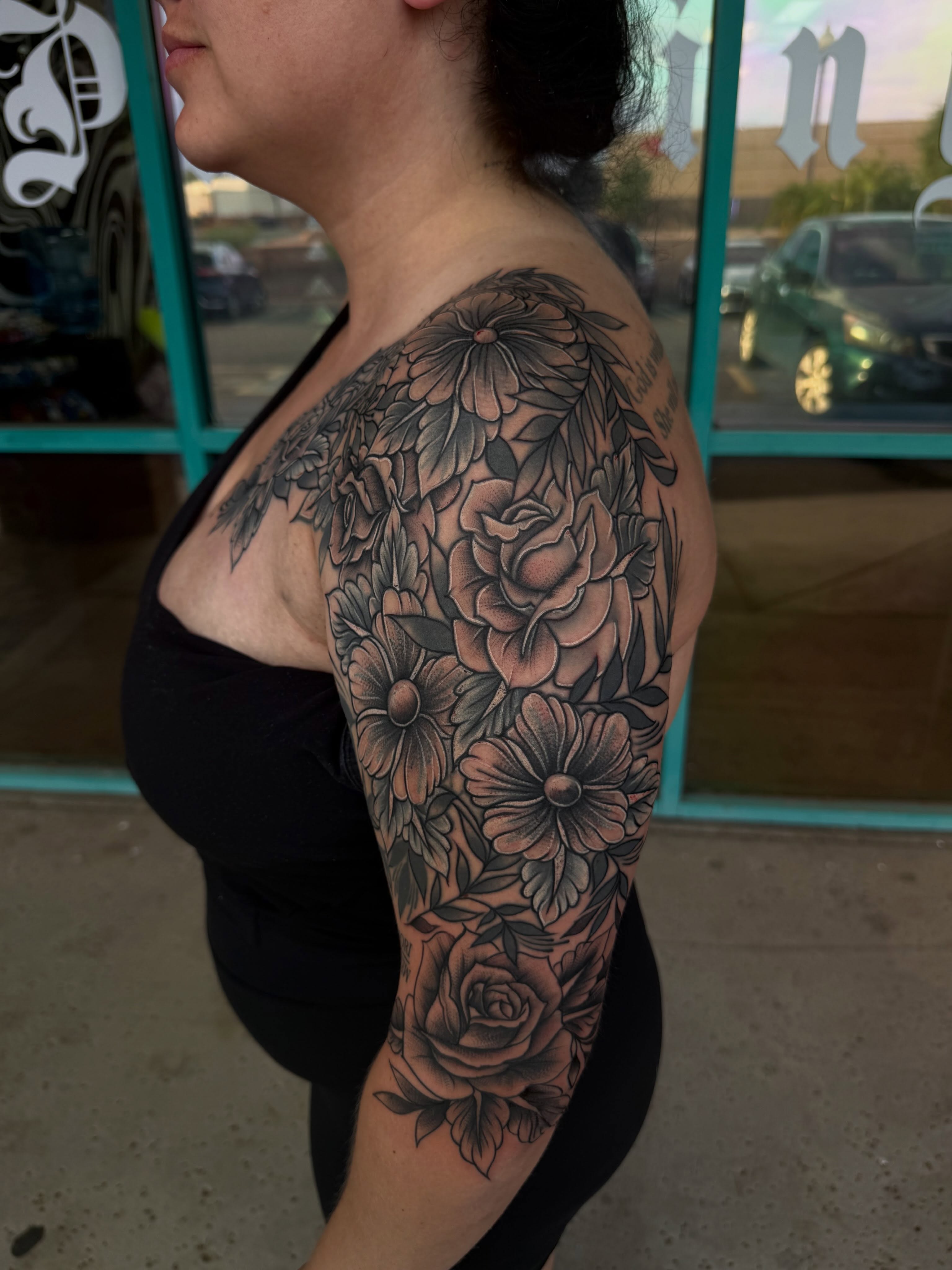 Floral bouquet black and grey tattoo on the shoulder by McKenna Hughes
