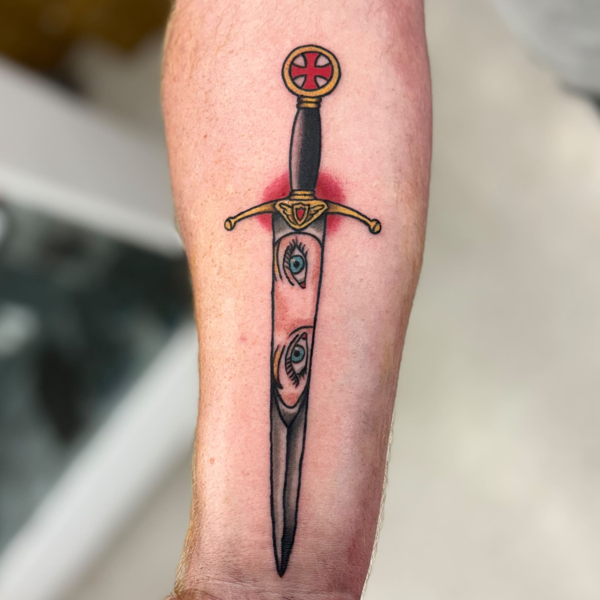 Sword with eyes realism tattoo on the forearm by Jon Anderson