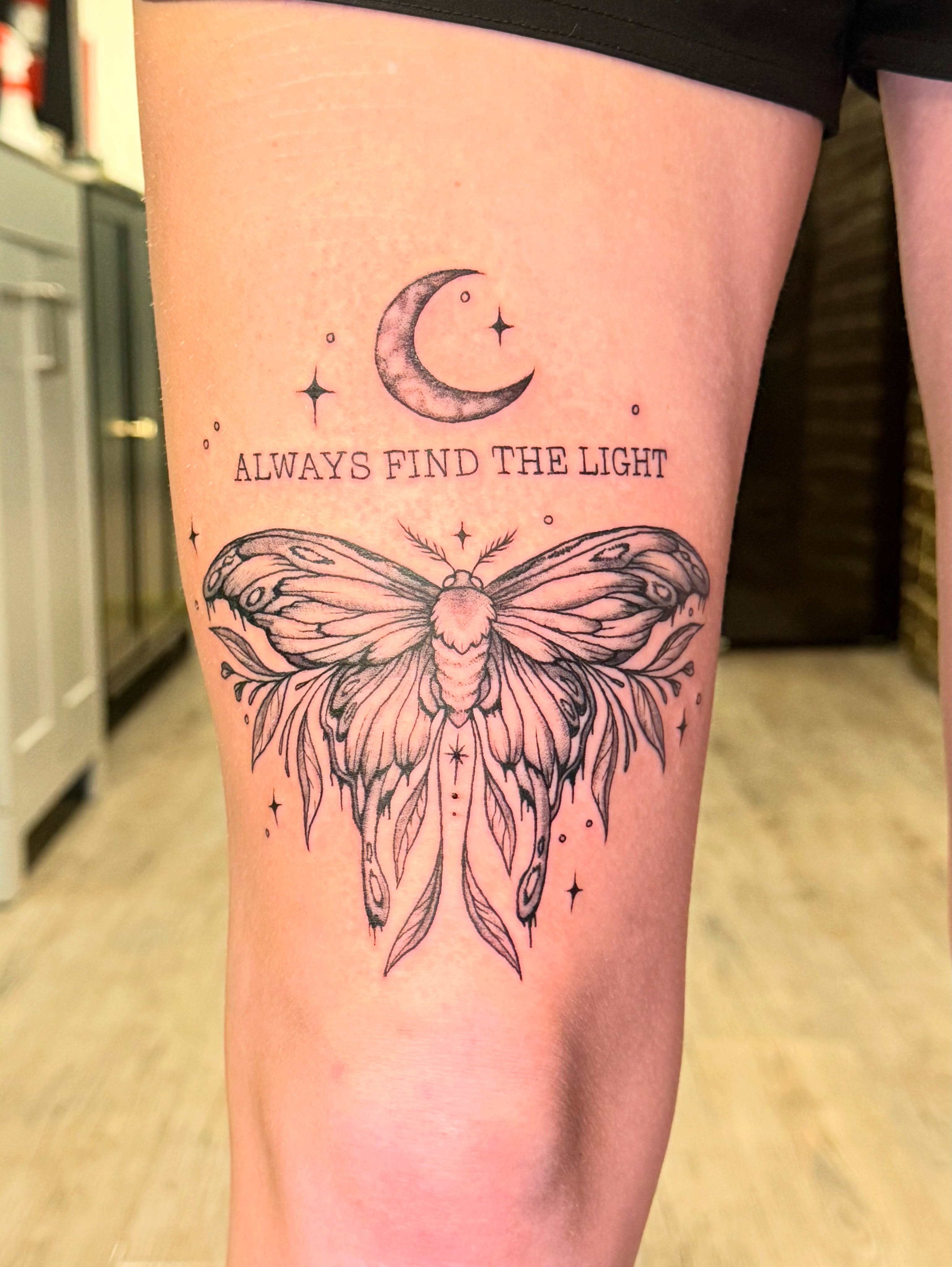 Moth and crescent moon dotwork tattoo on the thigh by Tyla Pistak, Seattle, Washington