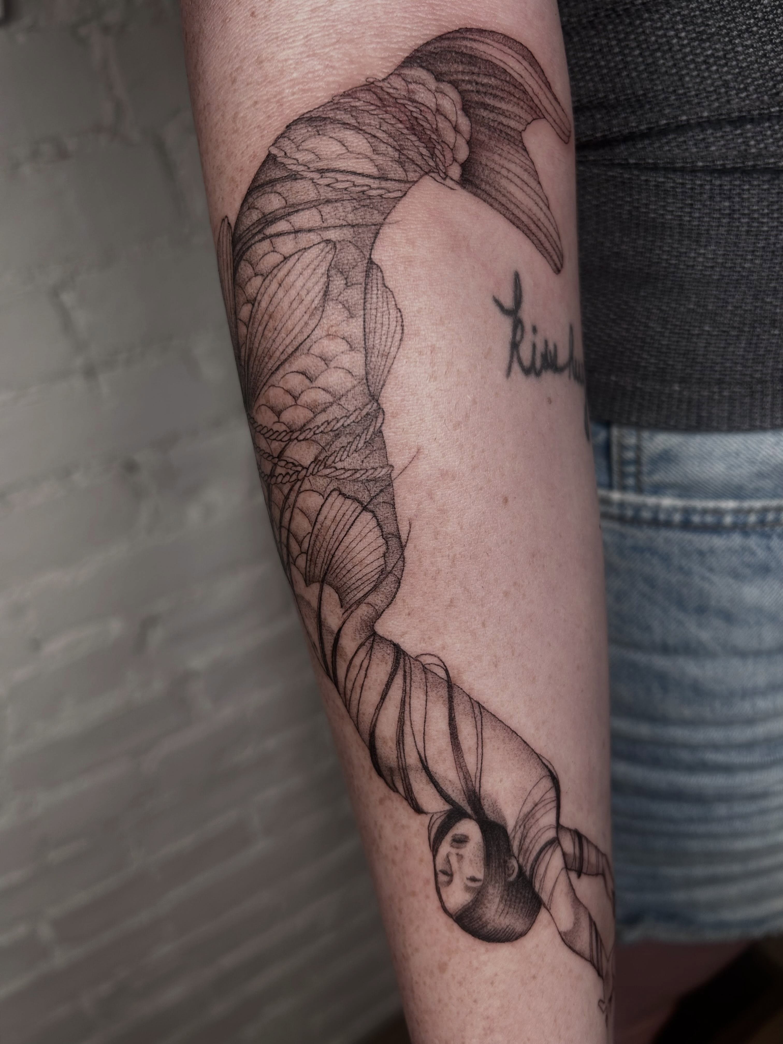 Koi fish black and grey tattoo on the forearm by Olivia Fox