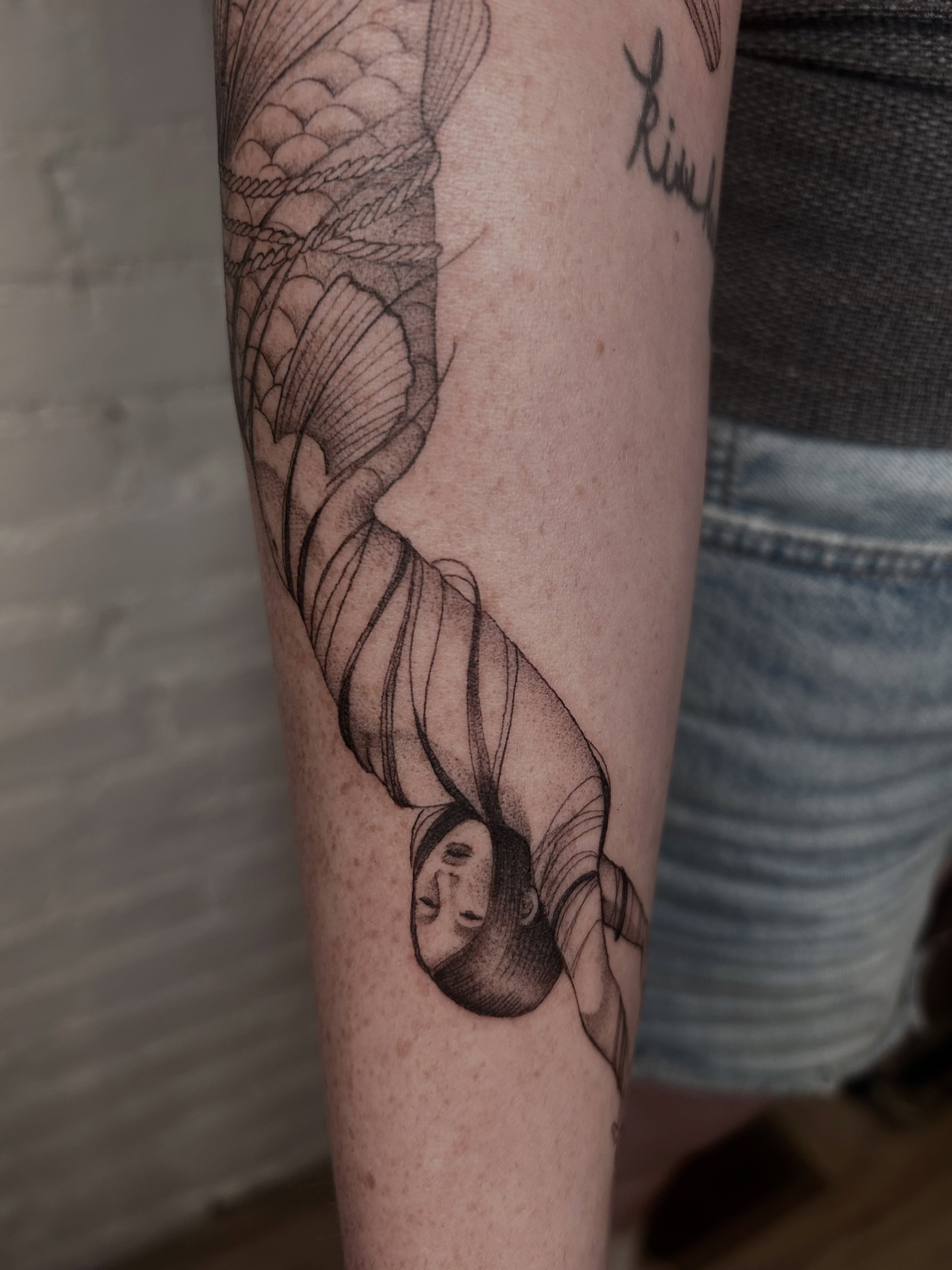 Woman's head entwined with rope realism tattoo on the forearm by Olivia Fox