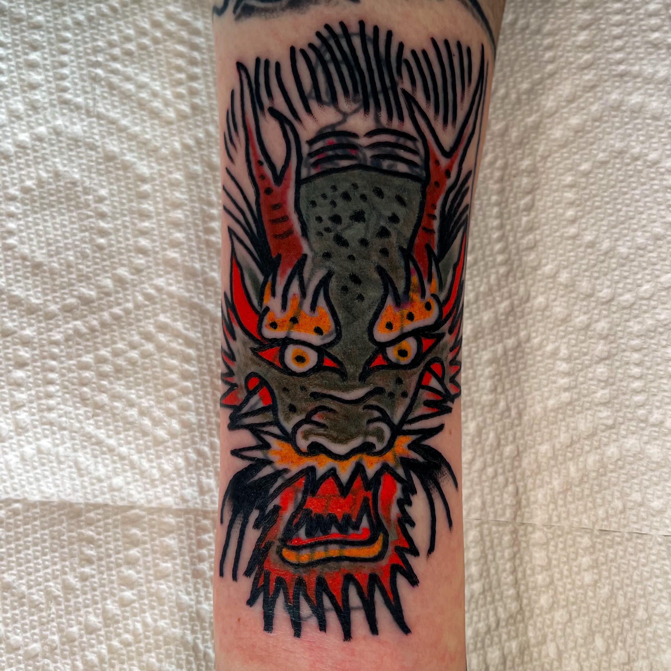 Lion American traditional tattoo on the forearm by Devyn Hightower