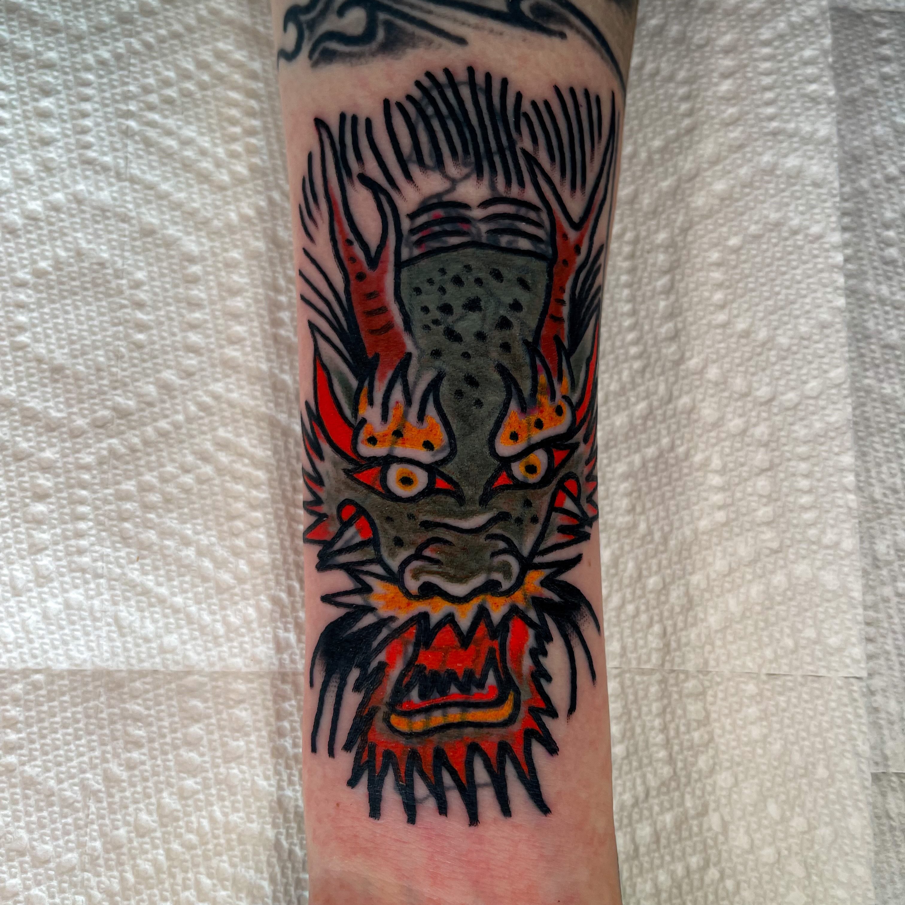 Demon mask American traditional tattoo on the forearm by Devyn Hightower