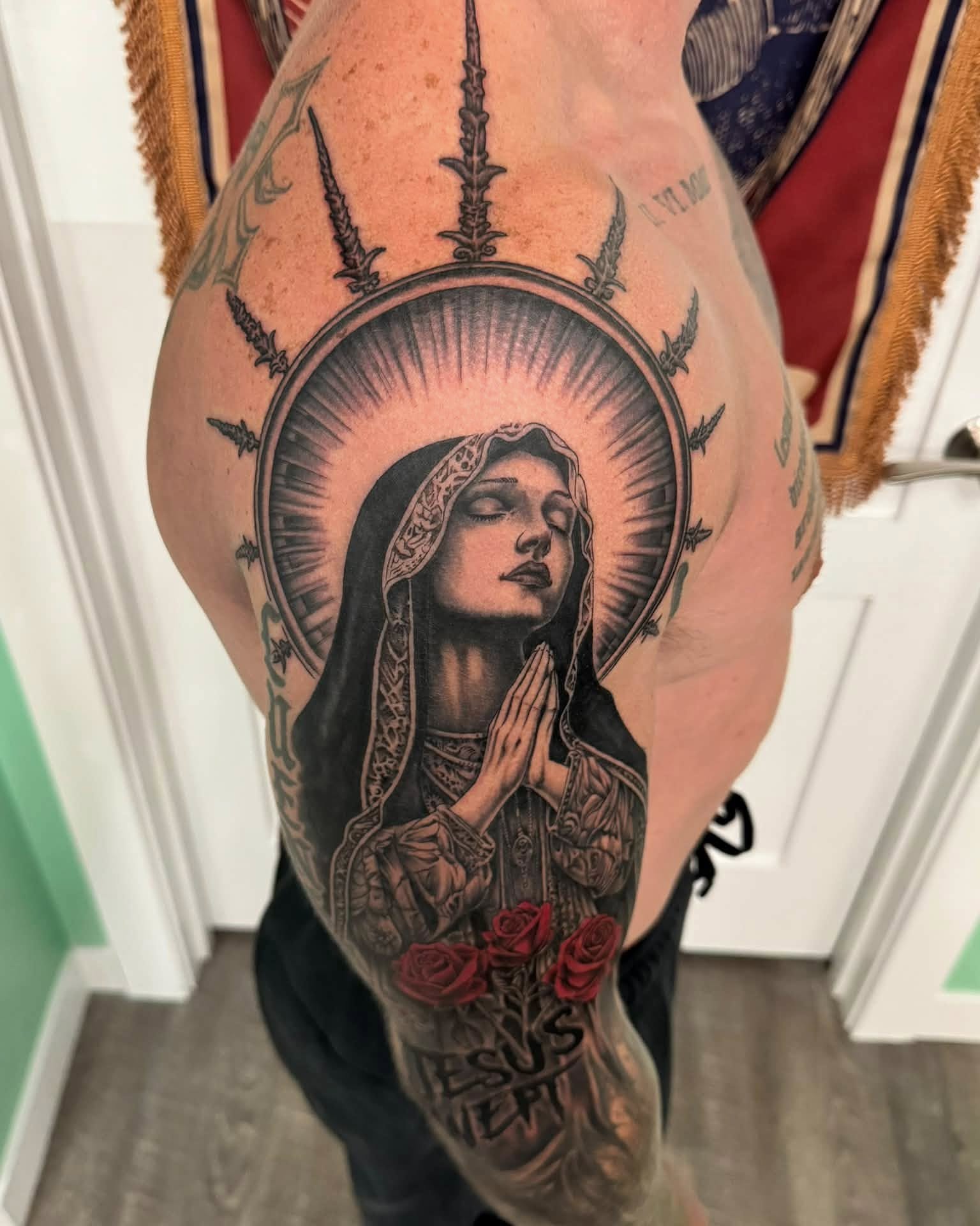Religious figure praying realism tattoo on the thigh by Skott Kautman, Dubuque, Iowa