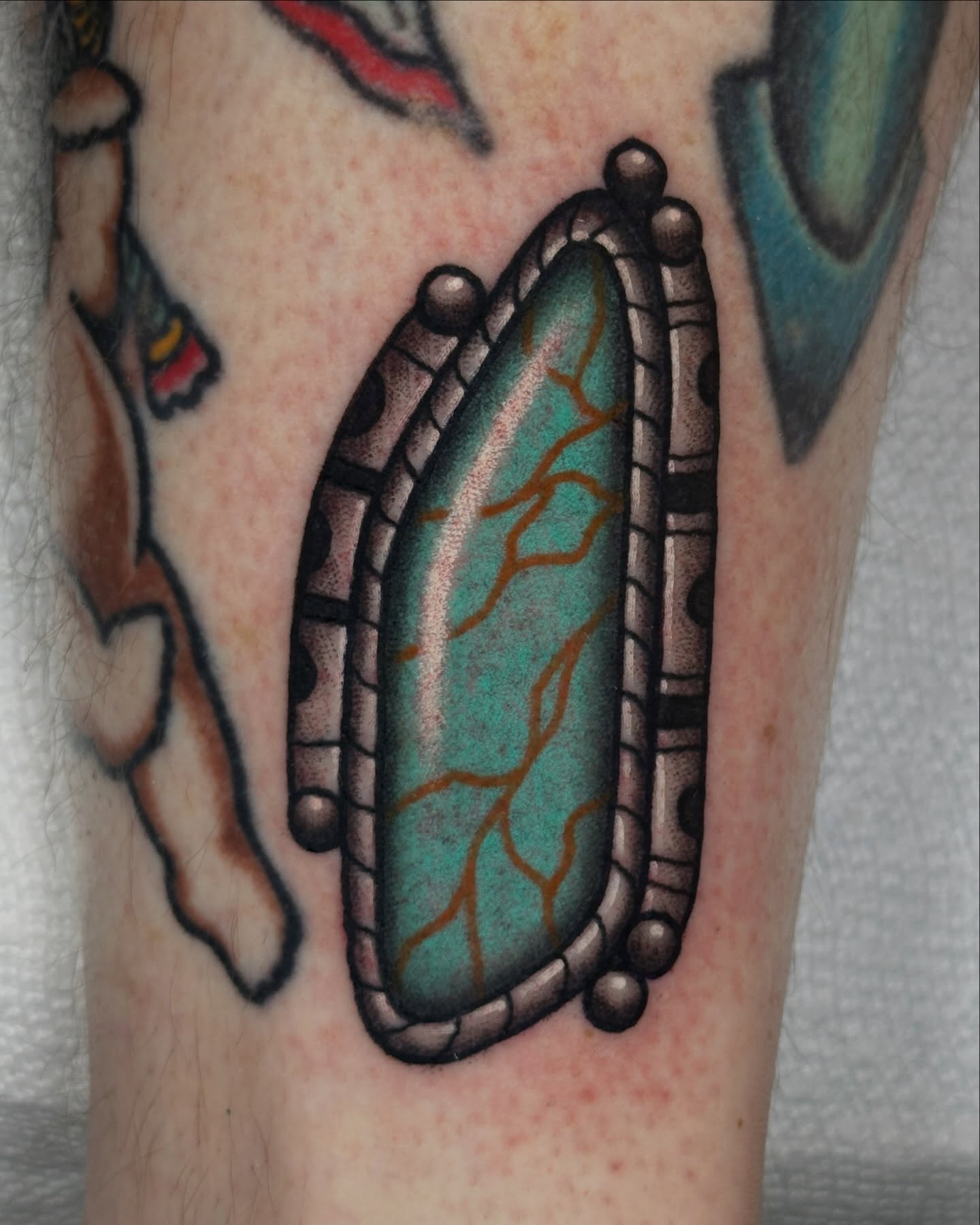 Gemstone American traditional tattoo on the forearm by Kyle Logan Frary