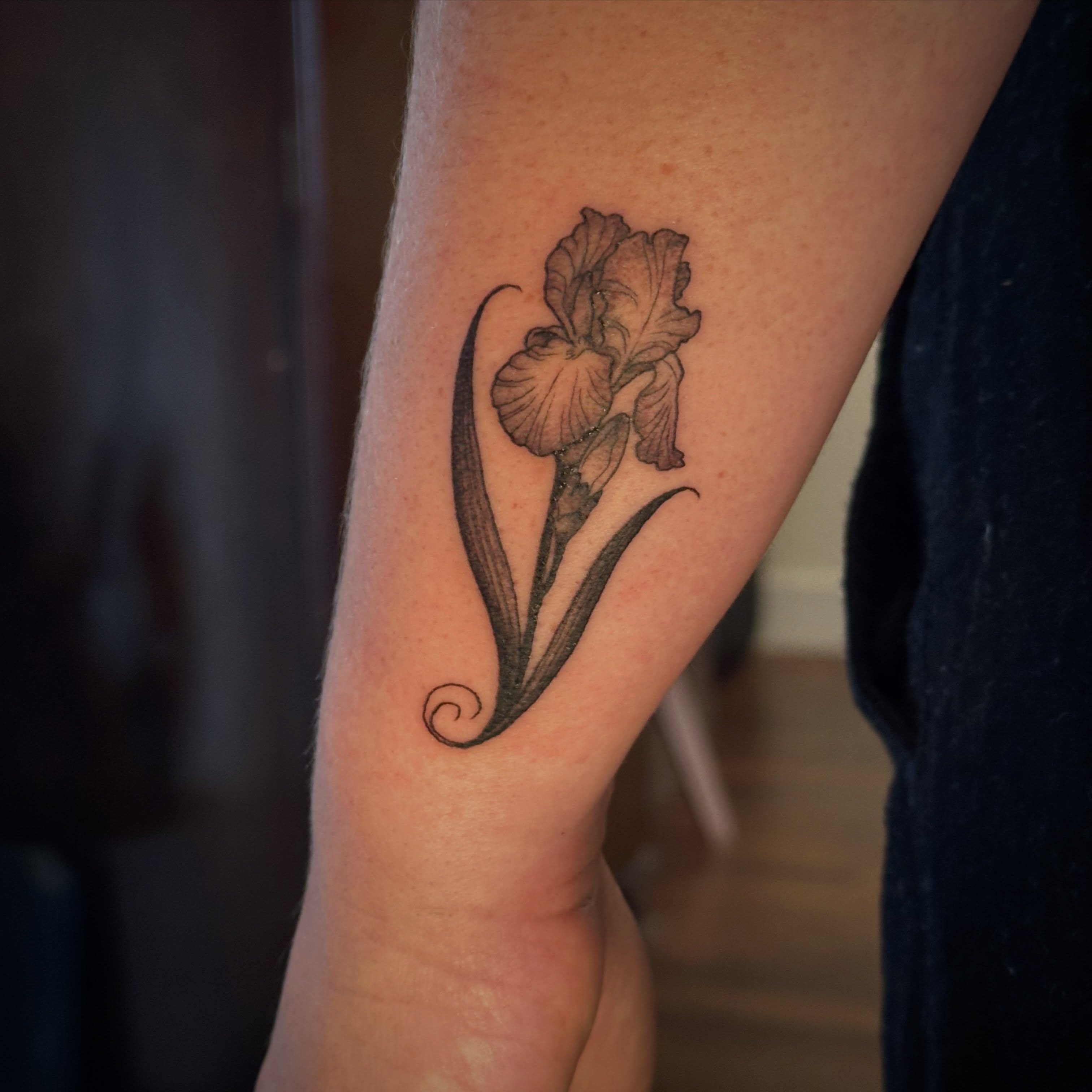 Iris black and grey tattoo on the forearm by Bree Lin