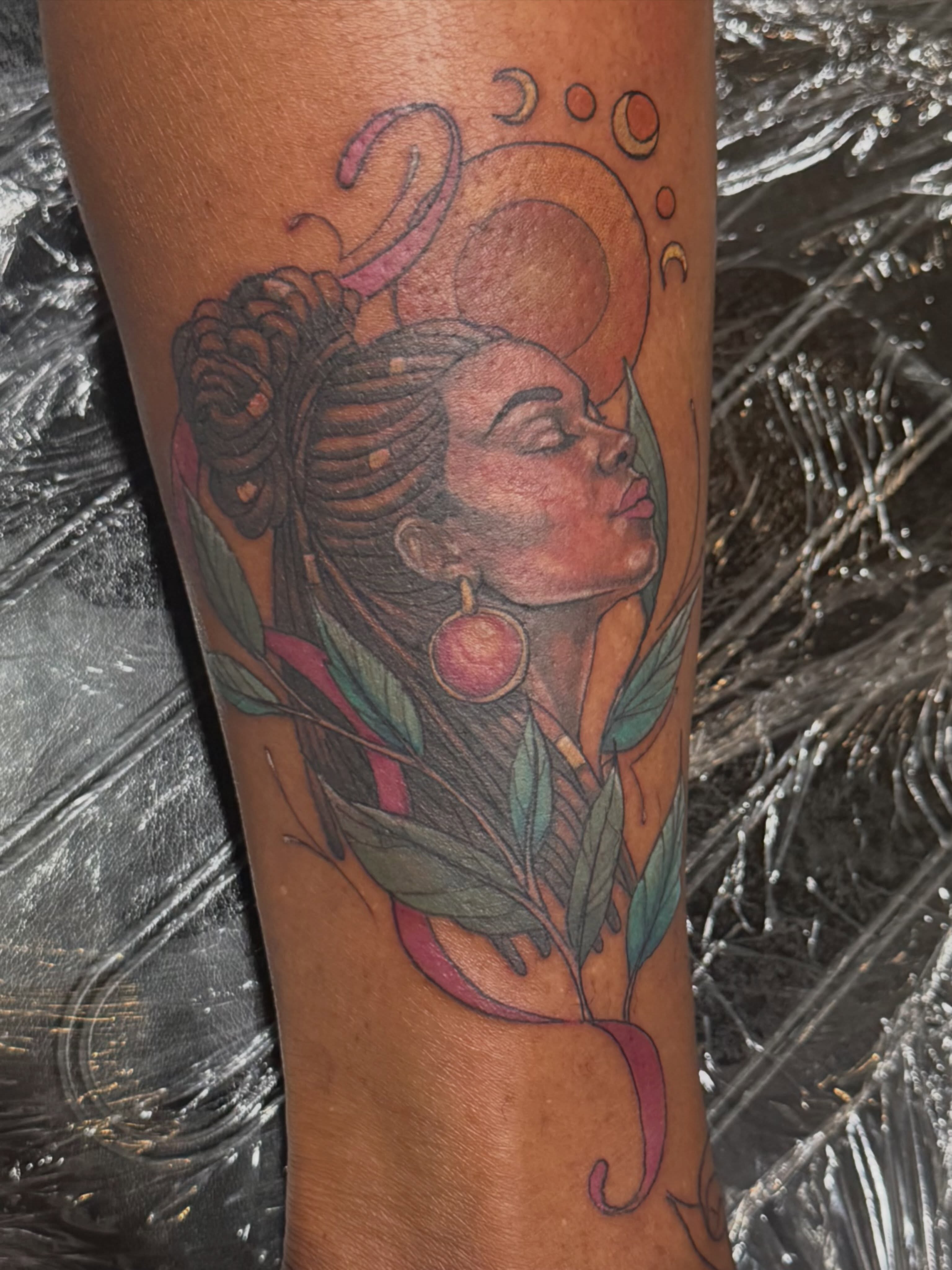 Woman with crescent moon illustrative tattoo on the forearm by Courtney