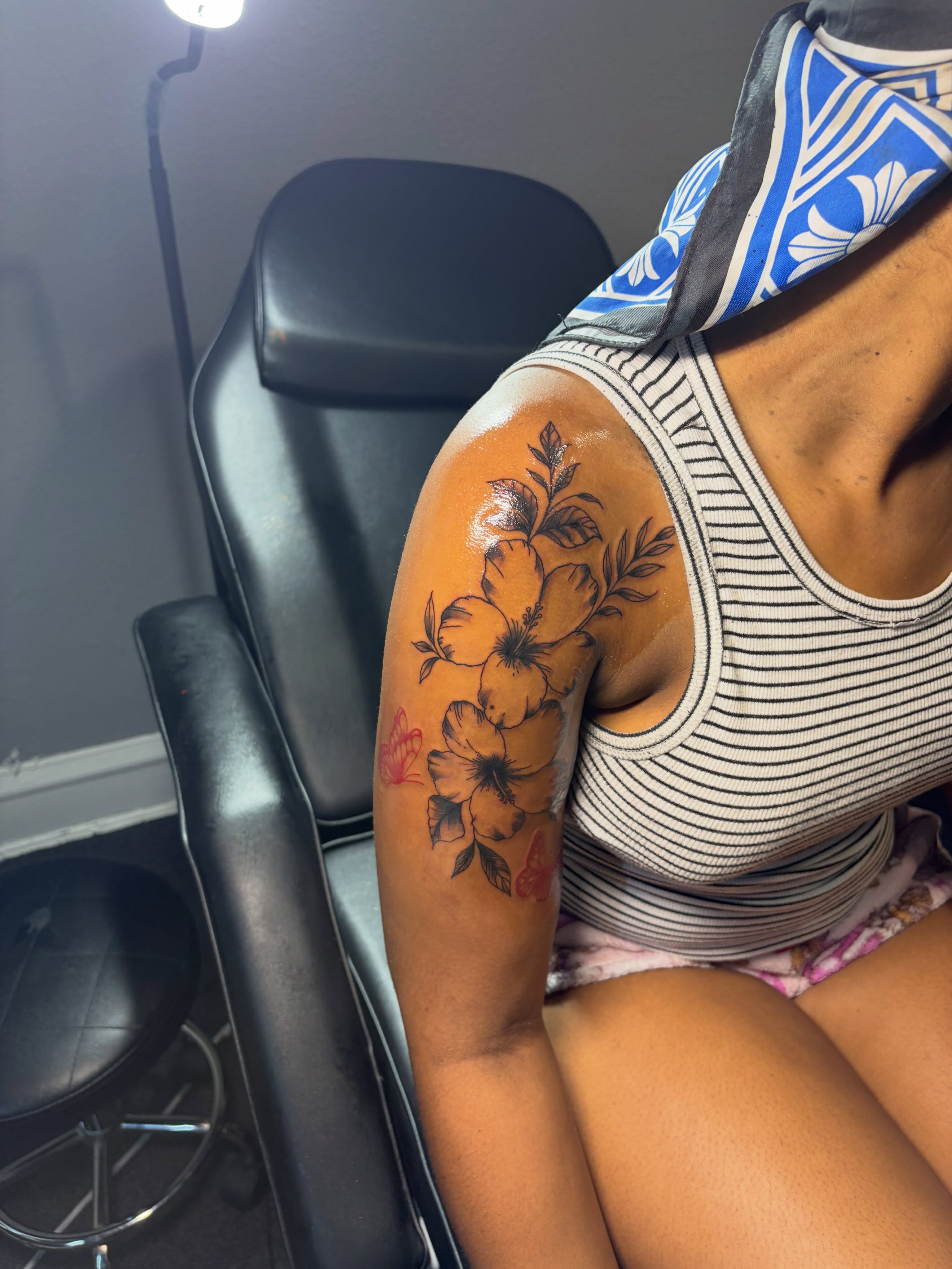 Hawaiian flowers American traditional tattoo on the upper arm by 216 Tattoos 🥰