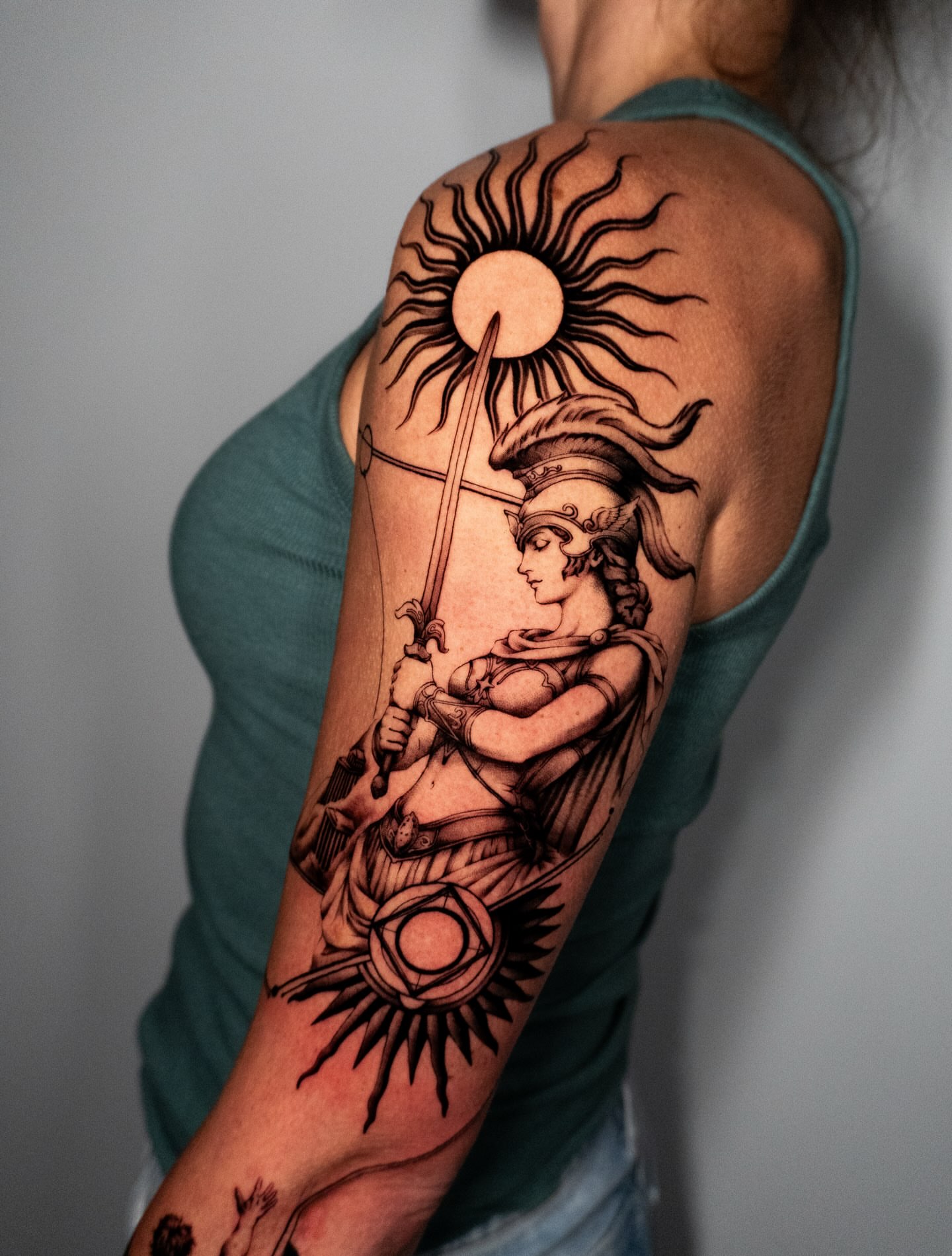 Warrior with sun black and grey tattoo on the upper arm by Moi Rivas, Salt Lake City, Utah