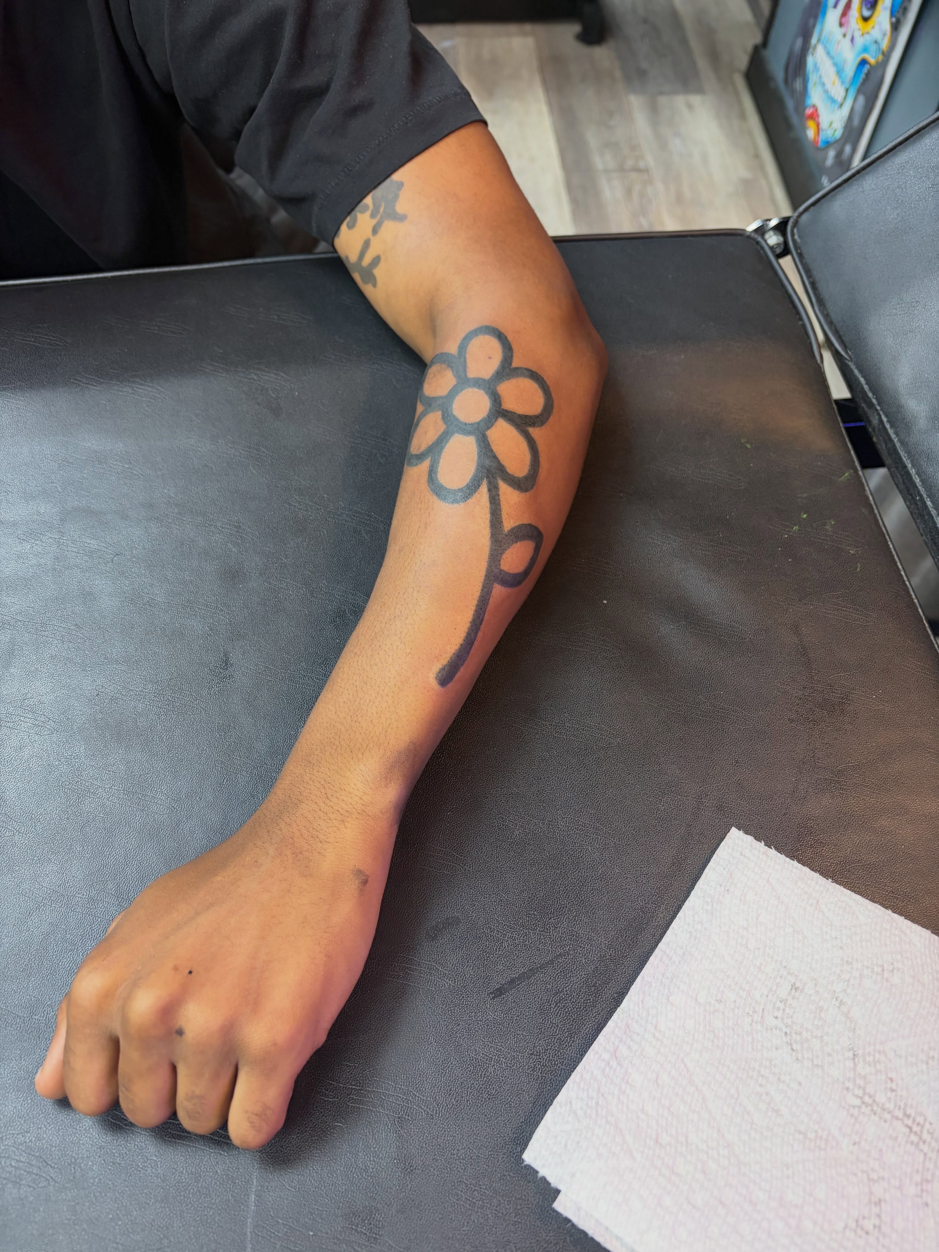 Flower black and grey tattoo on the forearm by Madison