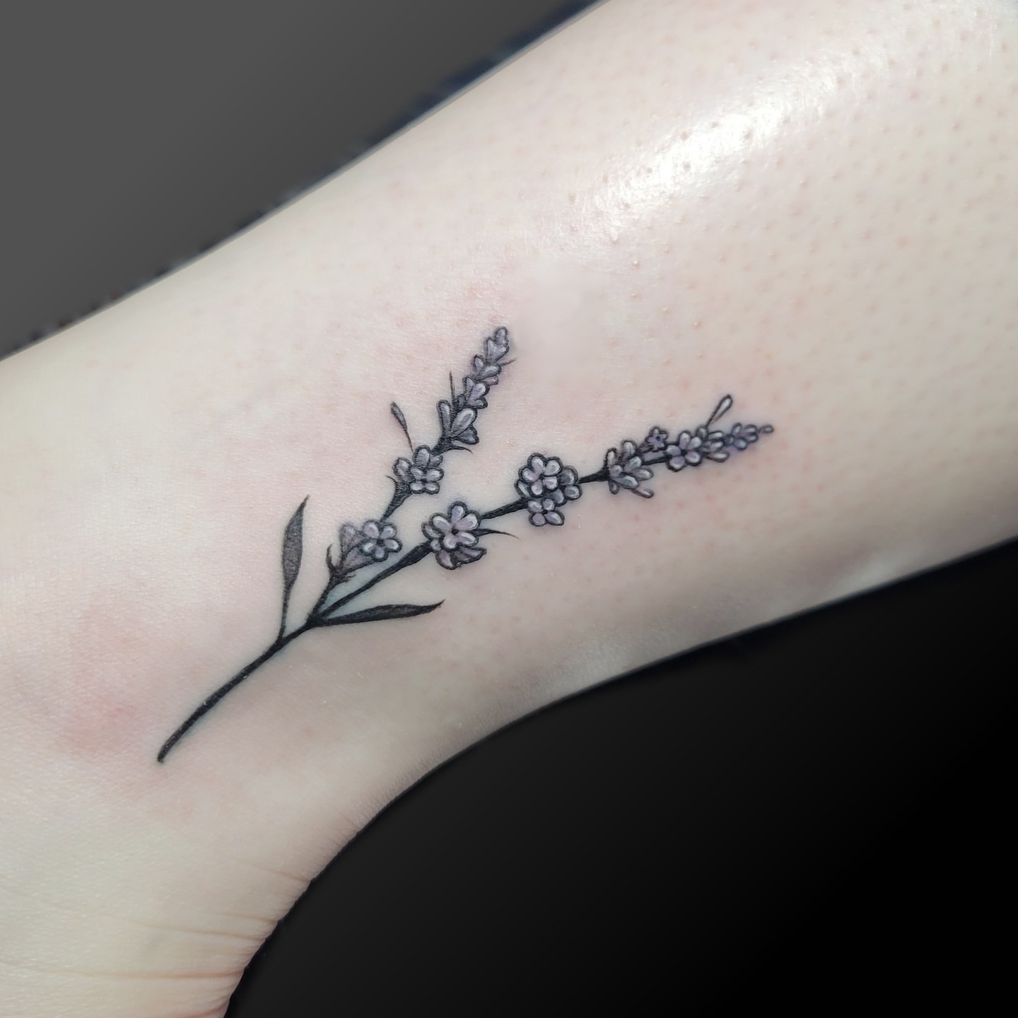 Flower branch black and grey tattoo on the forearm by Arick Reese