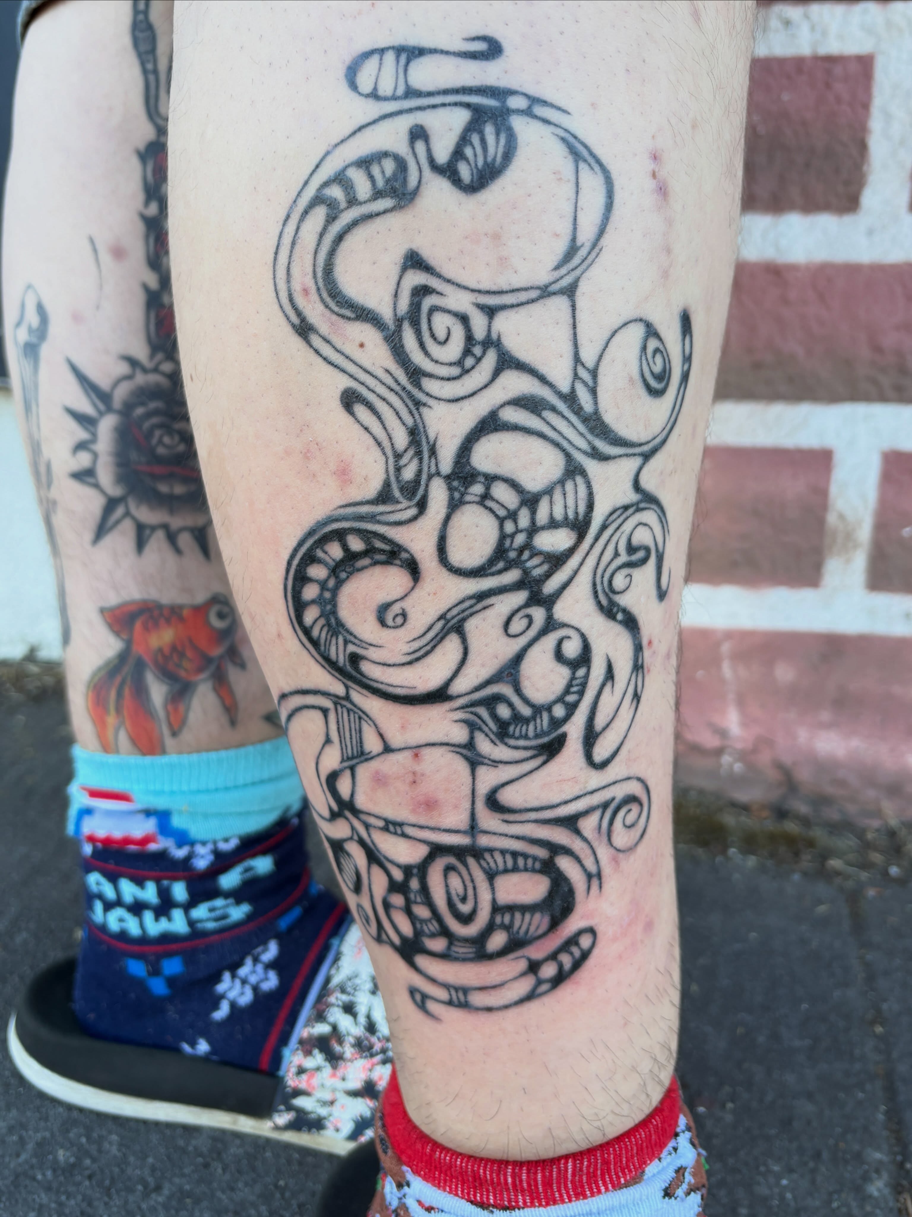 Serpent black and grey tattoo on the forearm by izzy solae