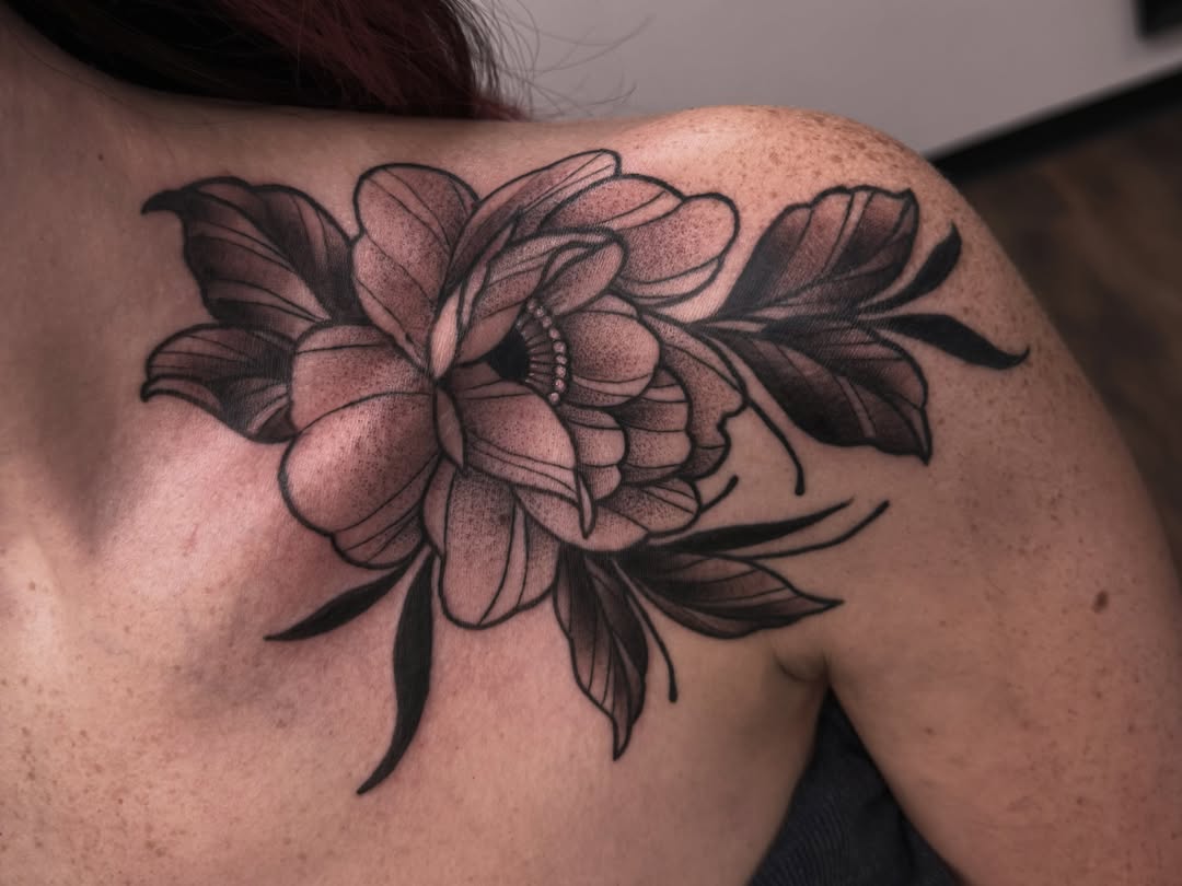 Flower black and grey tattoo on the shoulder by Sarah Foltz