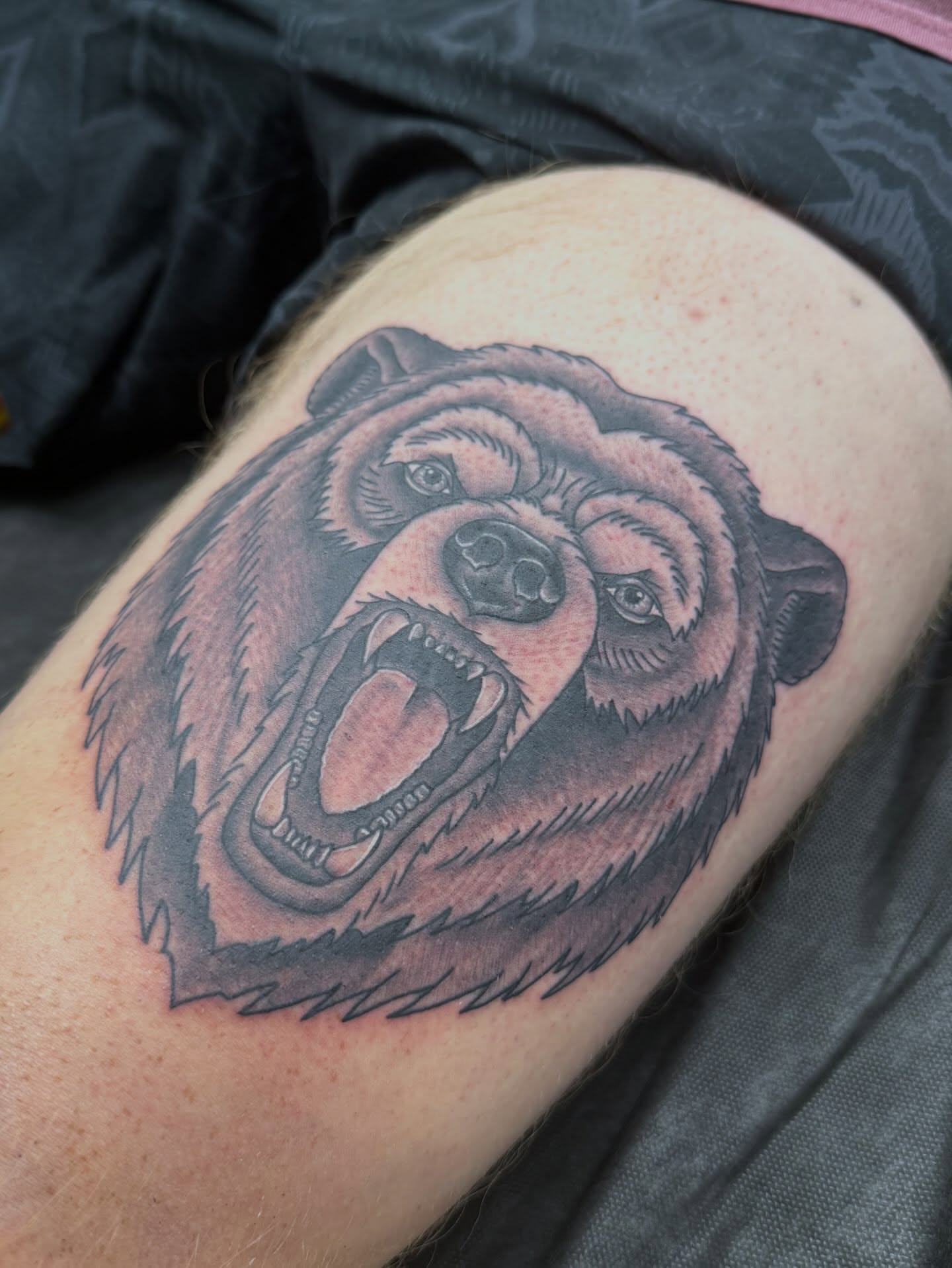 Angry bear black and grey tattoo on the thigh by Matt Hattaway