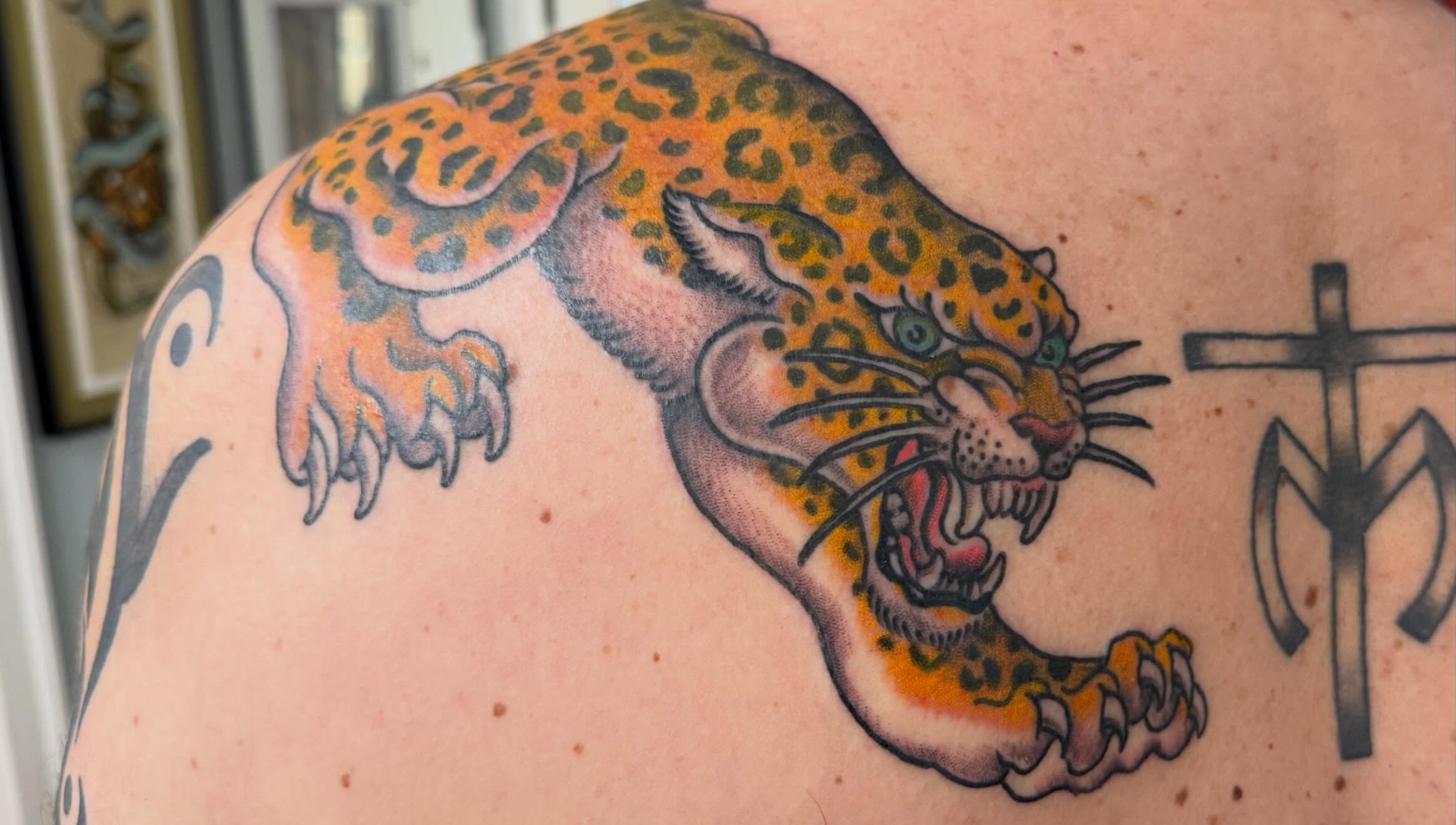 Jaguar American traditional tattoo on the shoulder by Tony Beuke