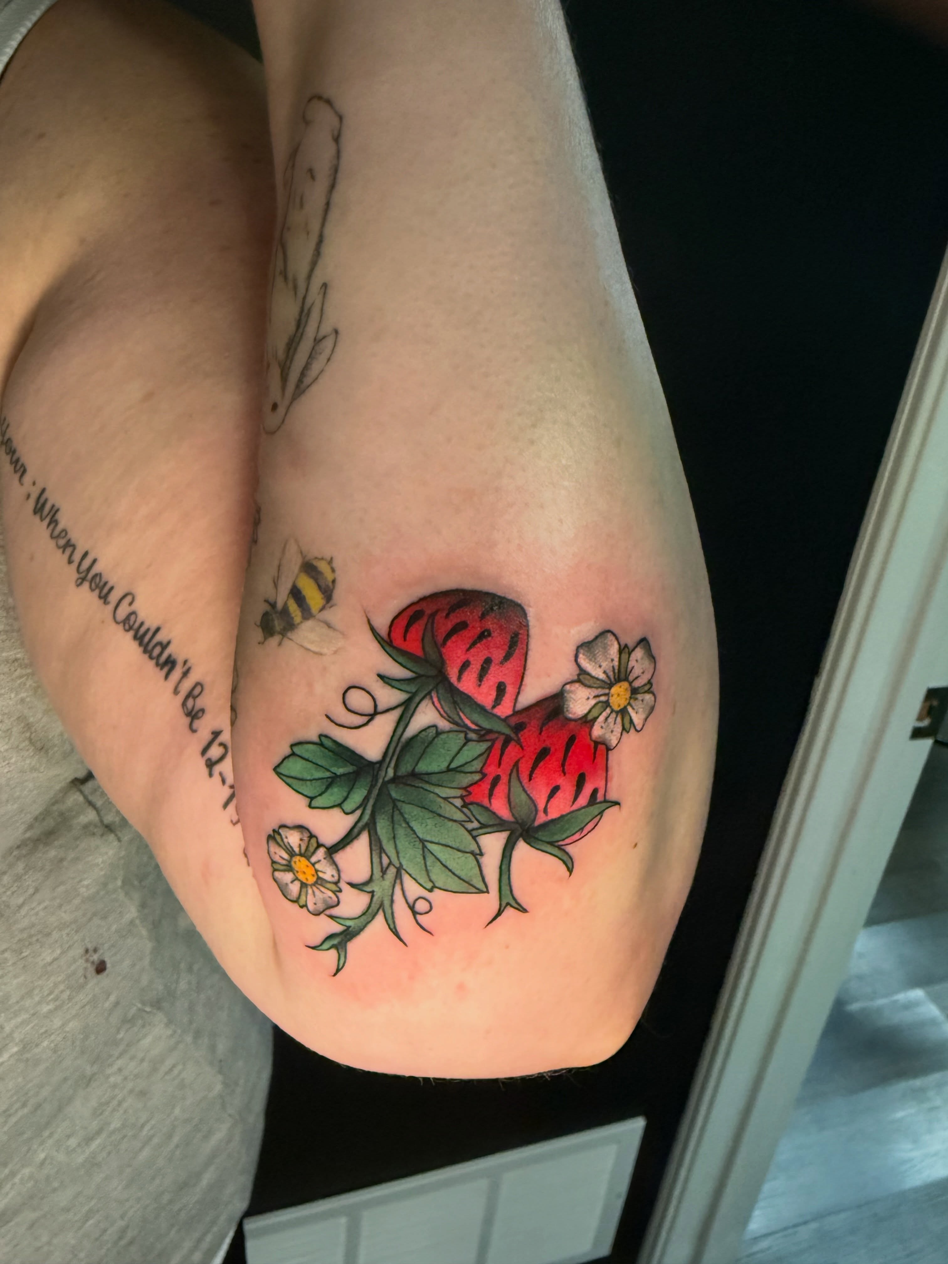 Strawberry and flowers new school tattoo on the thigh by Michelle Balhan