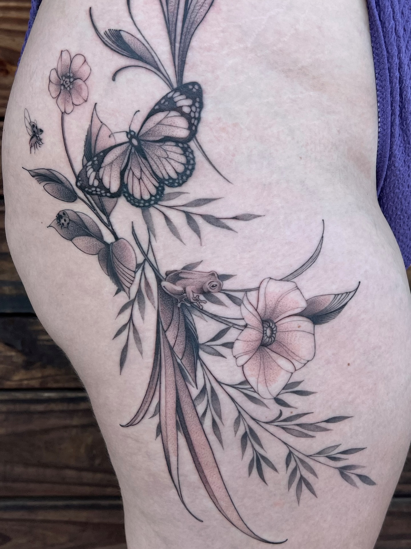 Butterfly and flowers realism tattoo on the thigh by Tehnaya