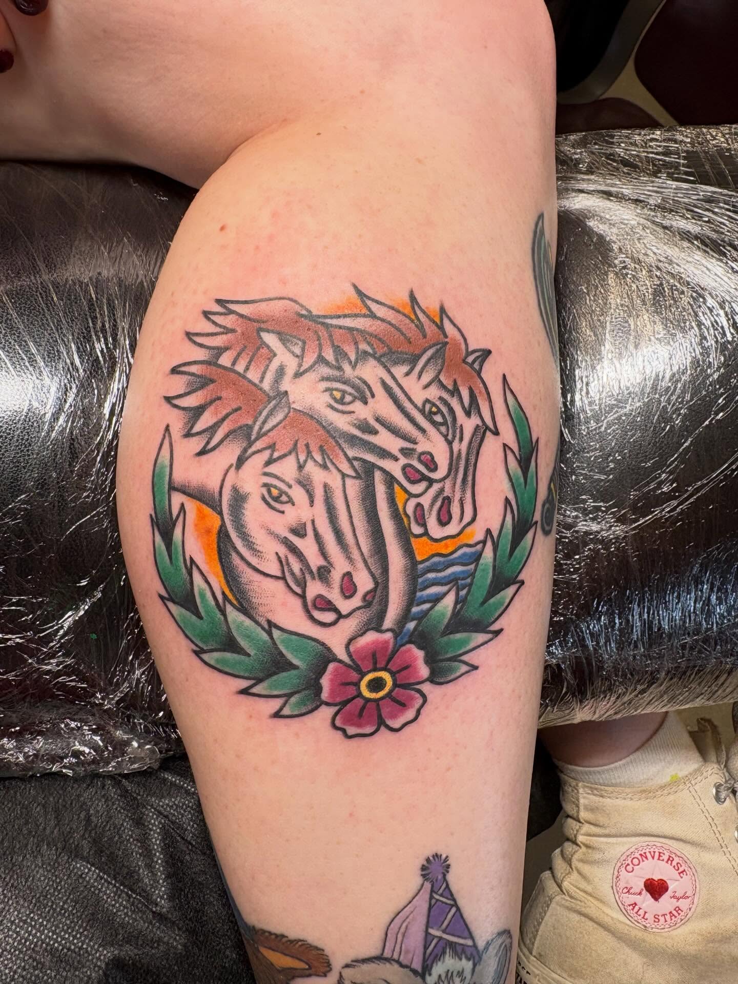 Horses and flower American traditional tattoo on the thigh by Gardner, Gardner, Massachusetts
