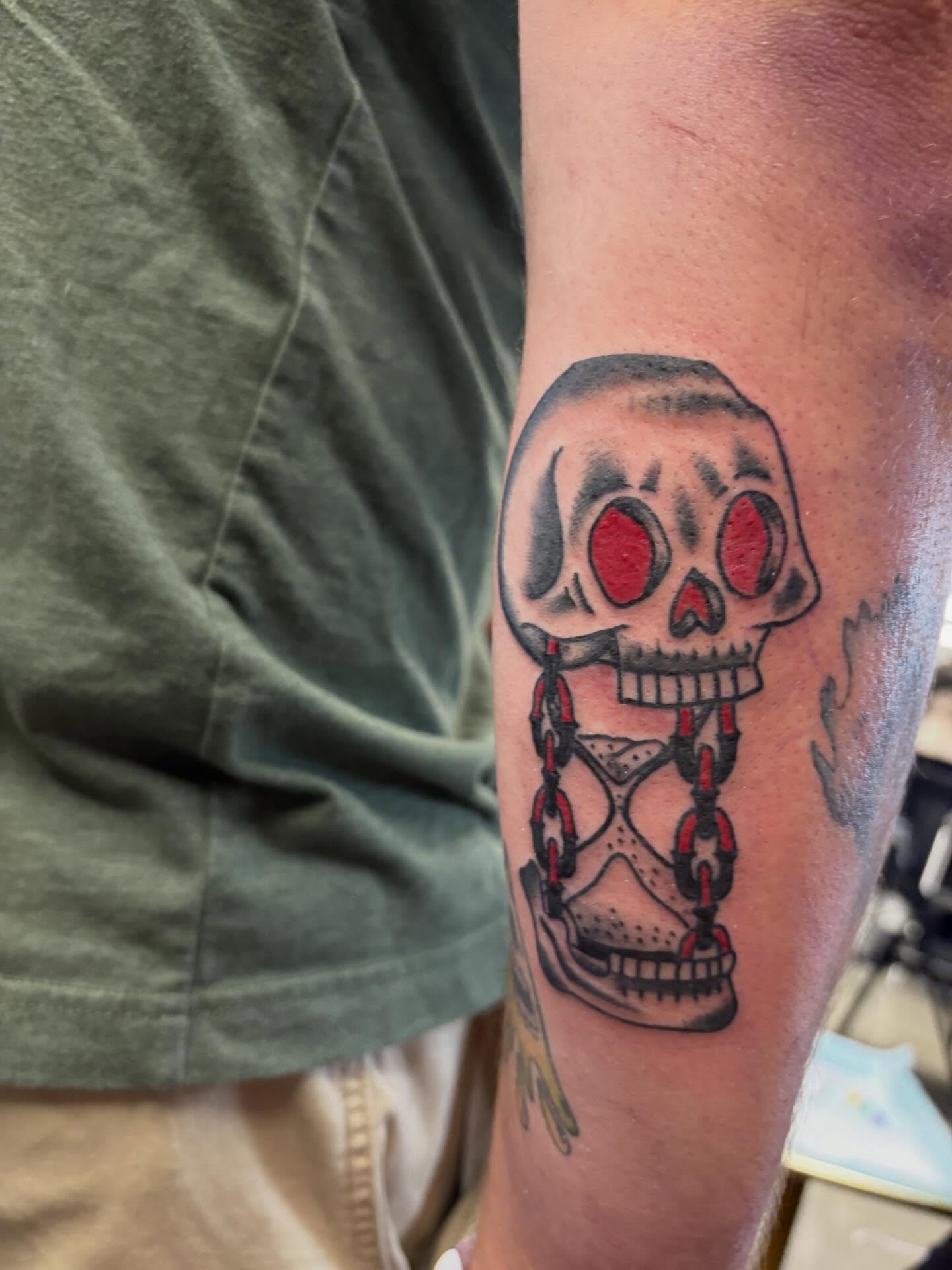 Skull with hourglass American traditional tattoo on the forearm by Gardner, Gardner, Massachusetts