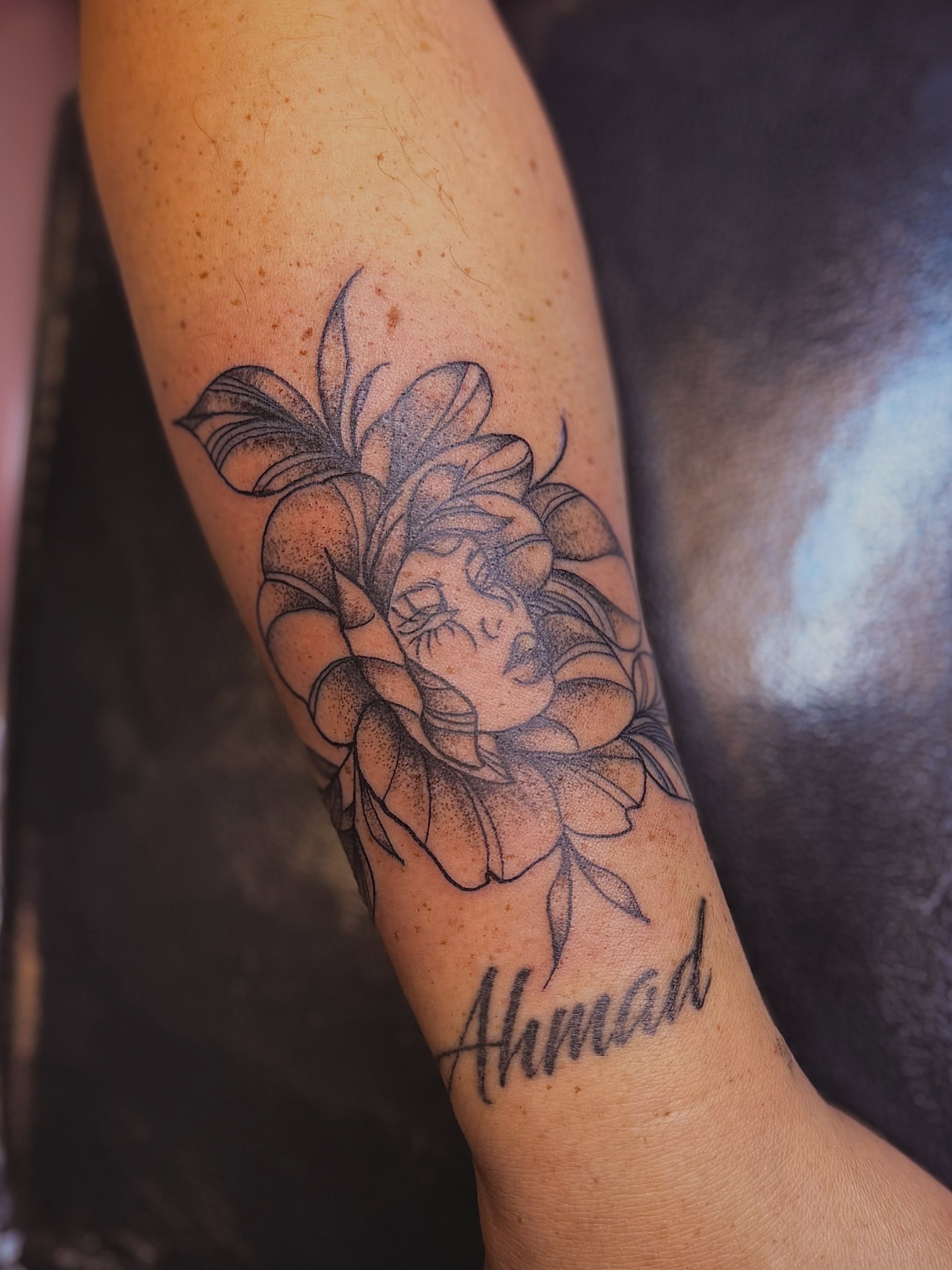 Flower with face dotwork tattoo on the forearm by Alesia