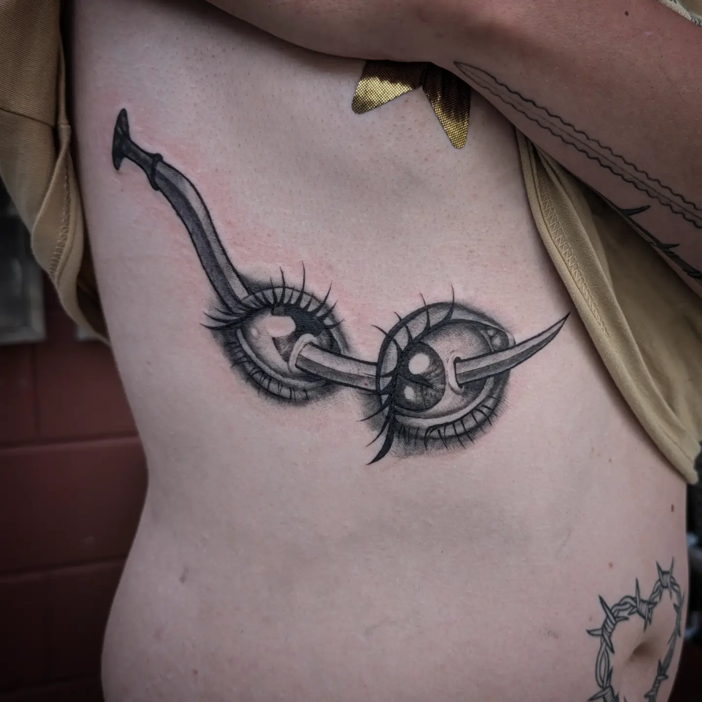 Eyes with sword realism tattoo on the ribs by Jo Xylo - Minneapolis Tattoo Artist, Minneapolis, Minnesota