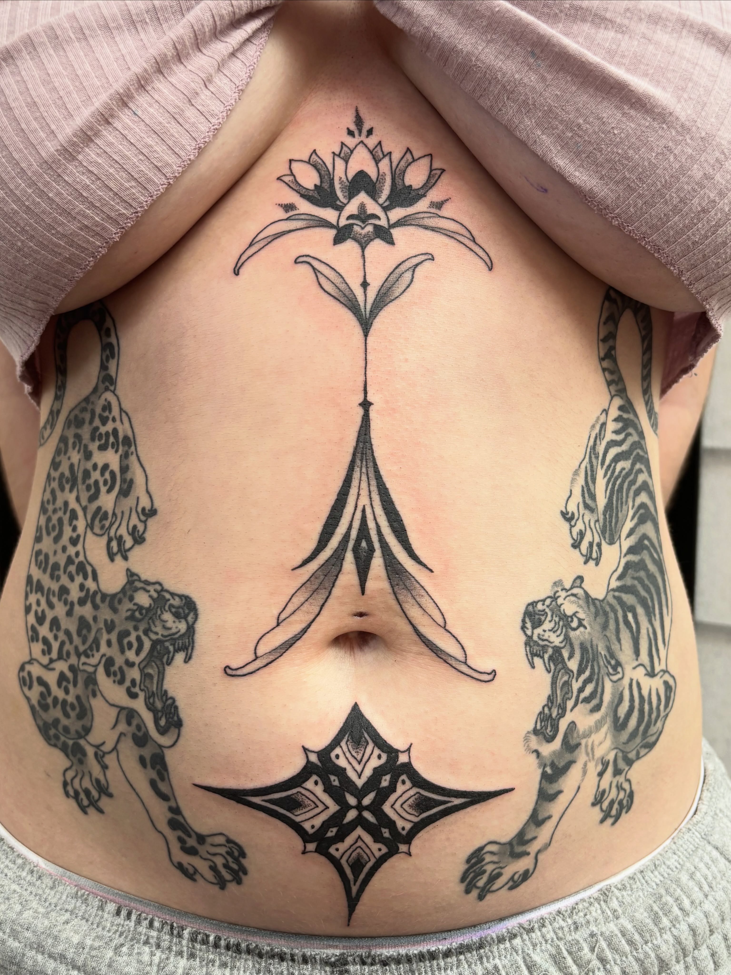 Lotus and leopards geometric tattoo on the torso by Adam Bailey, Portland, Oregon