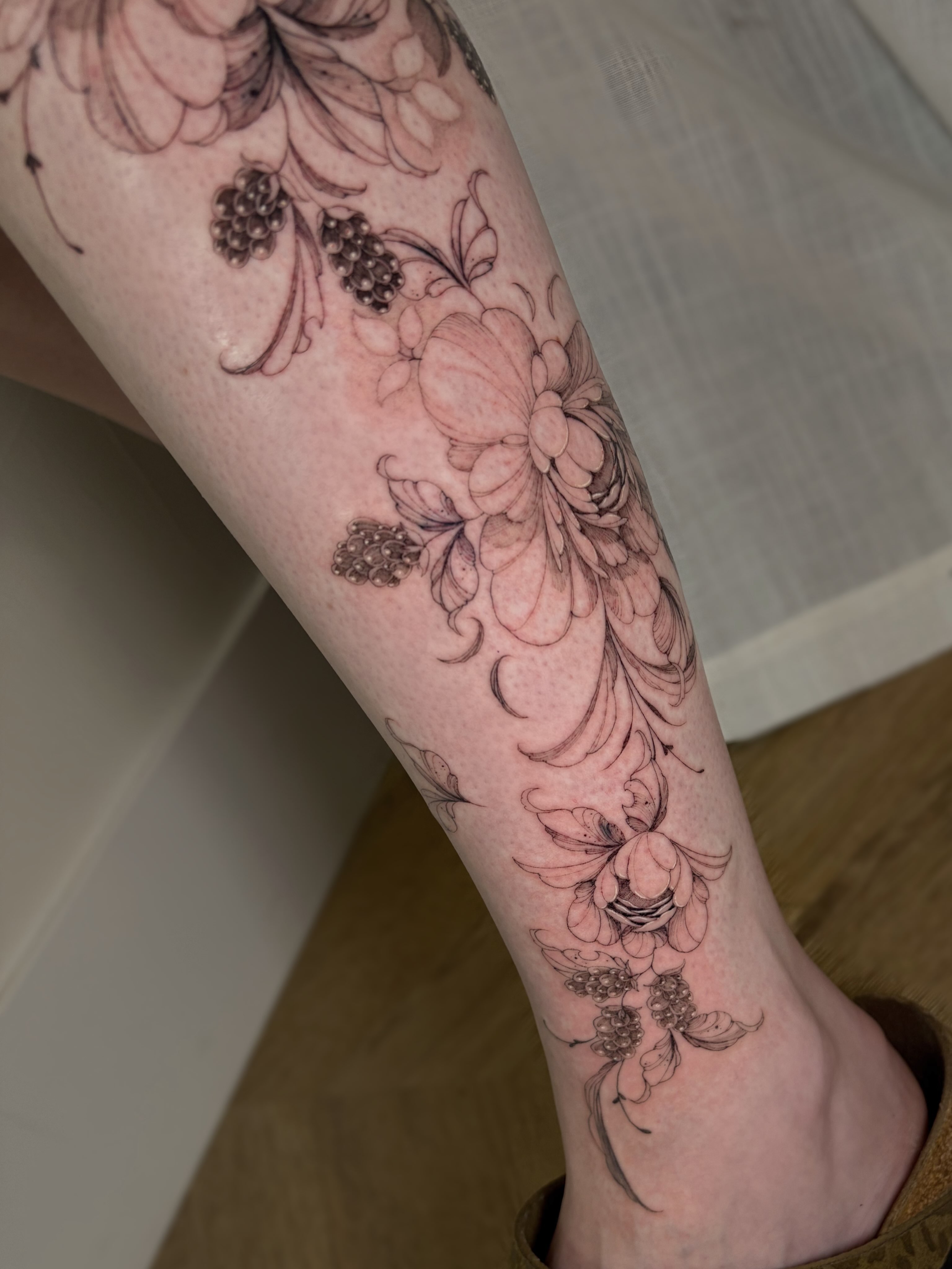 Floral arrangement black and grey tattoo on the forearm by Justene Renee 🖤 Fine Line Tattoo Artist
