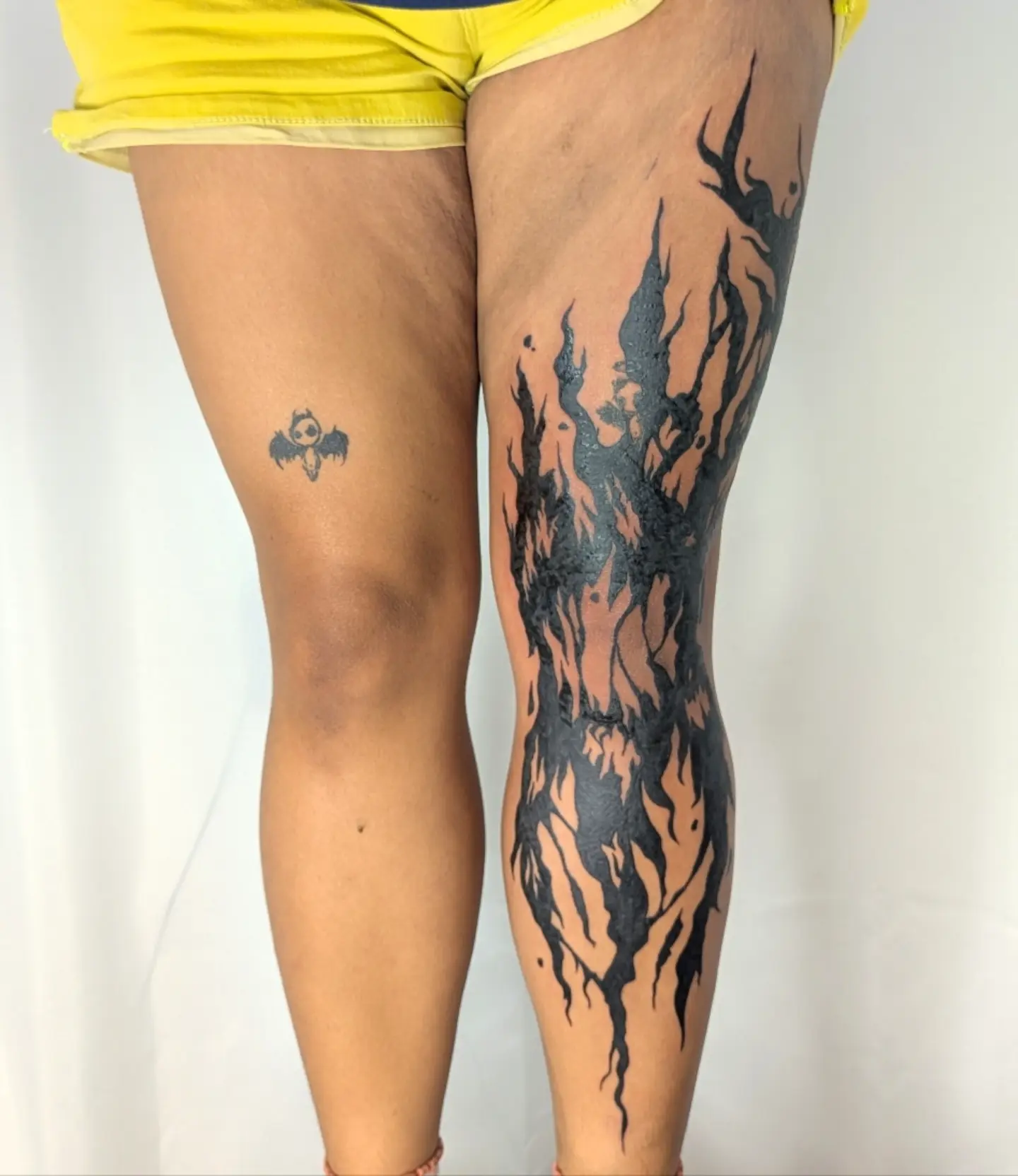 Flame black and grey tattoo on the leg by Nenookaasi Martin