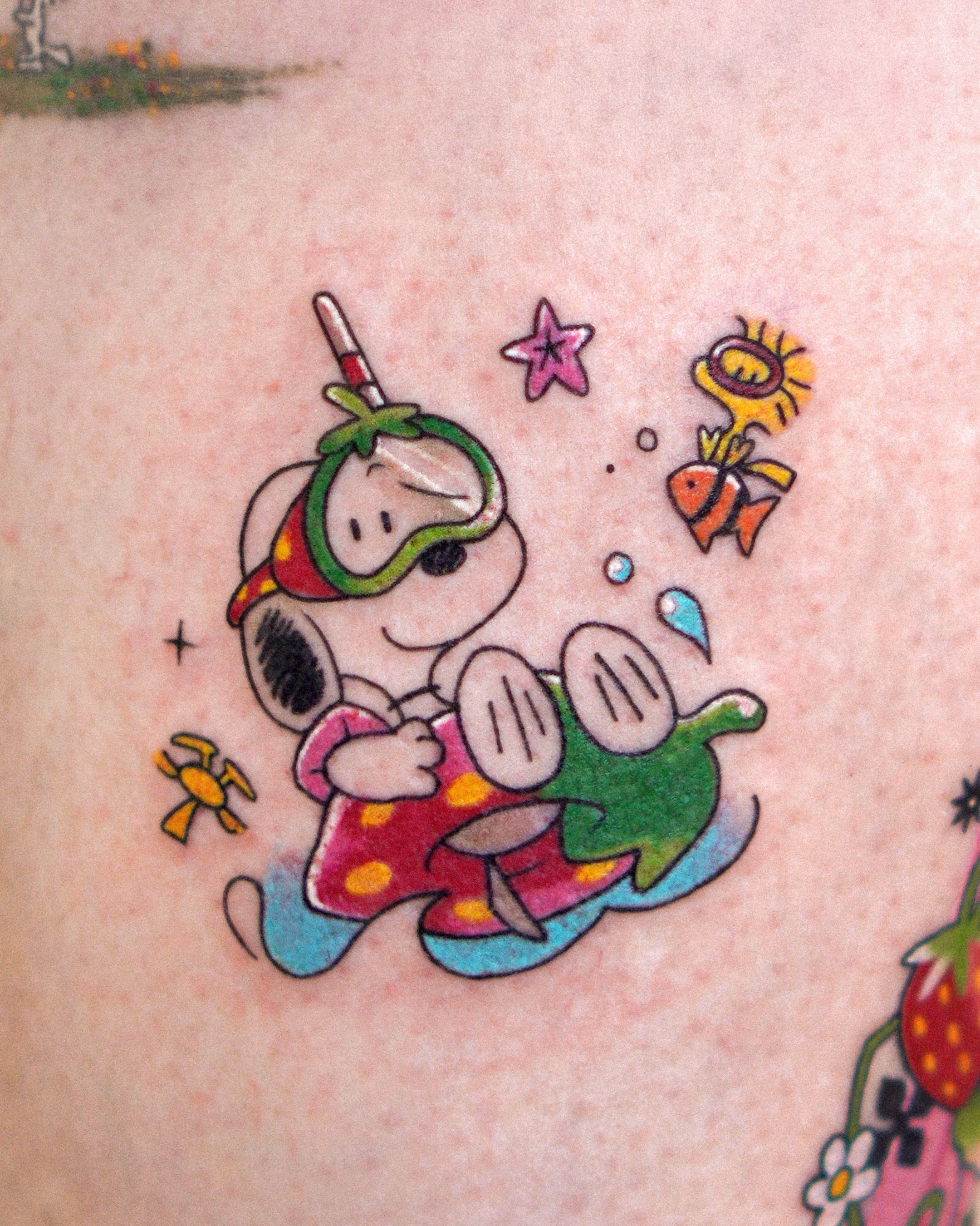 Snoopy diving new school tattoo on the upper arm by Eden