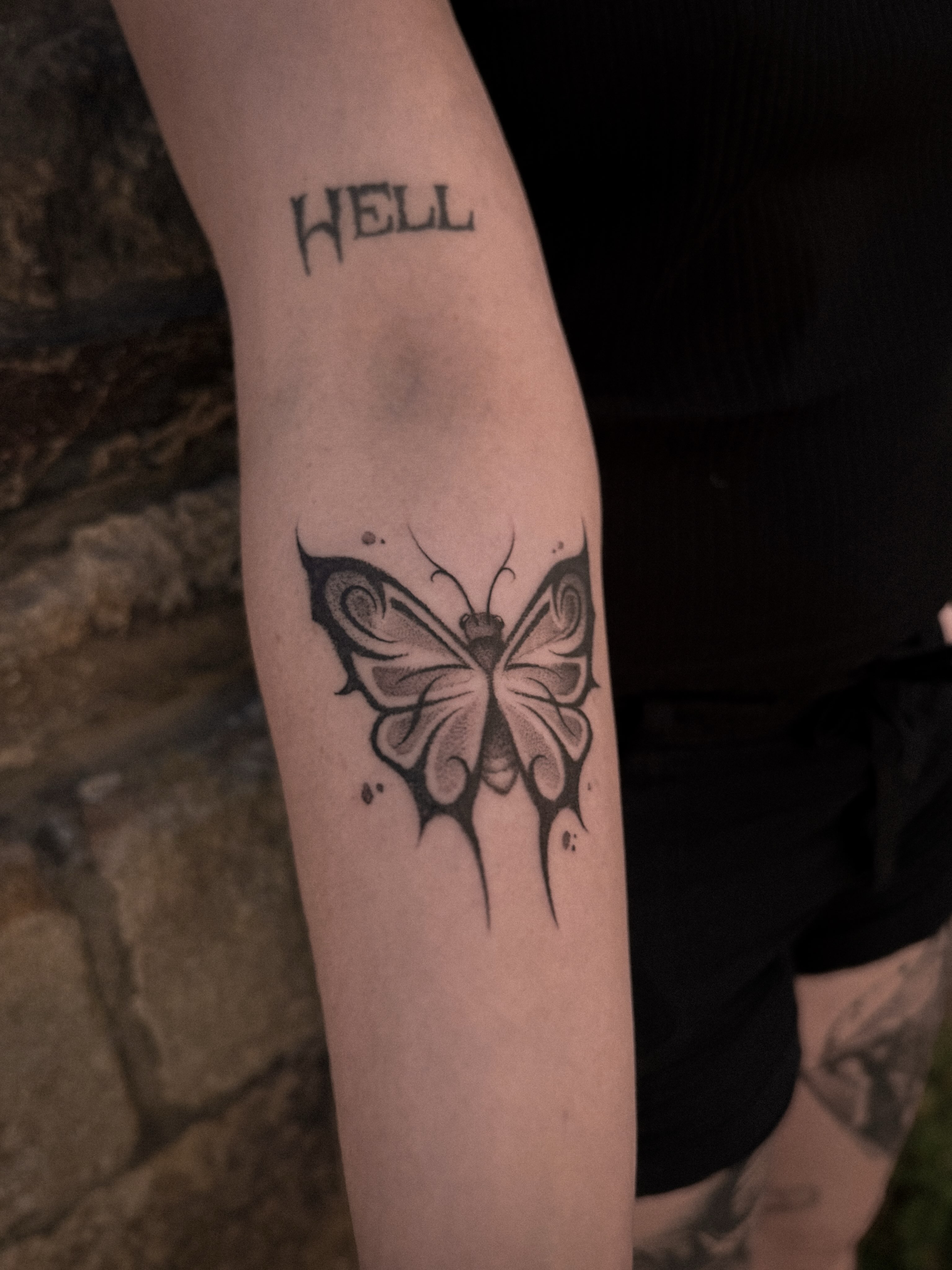 Butterfly black and grey tattoo on the forearm by La Hyene