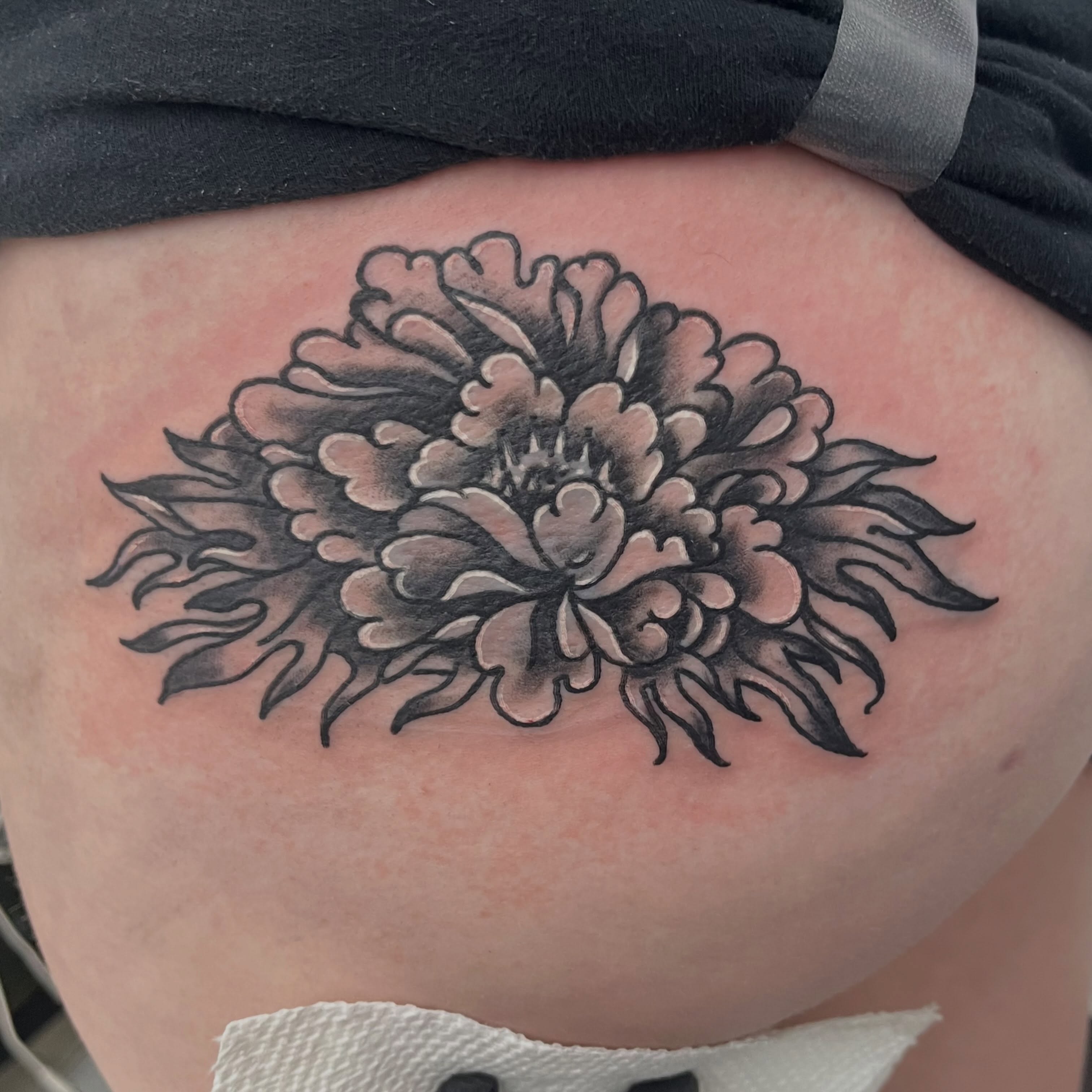 Flower black and grey tattoo on the thigh by Sour Tattoo, Somerville, Massachusetts