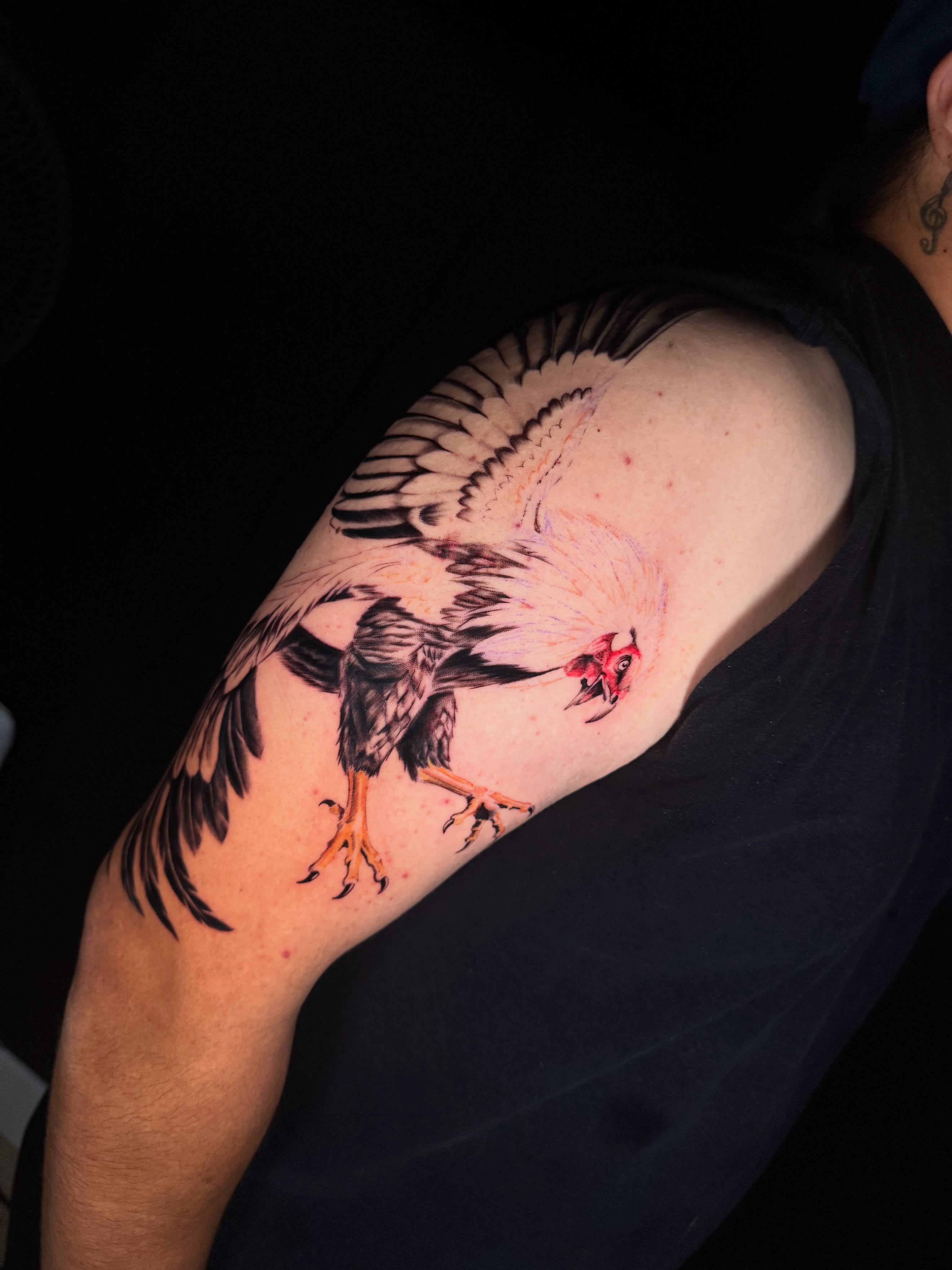 Rooster realism tattoo on the upper arm by Monica Gonzalez