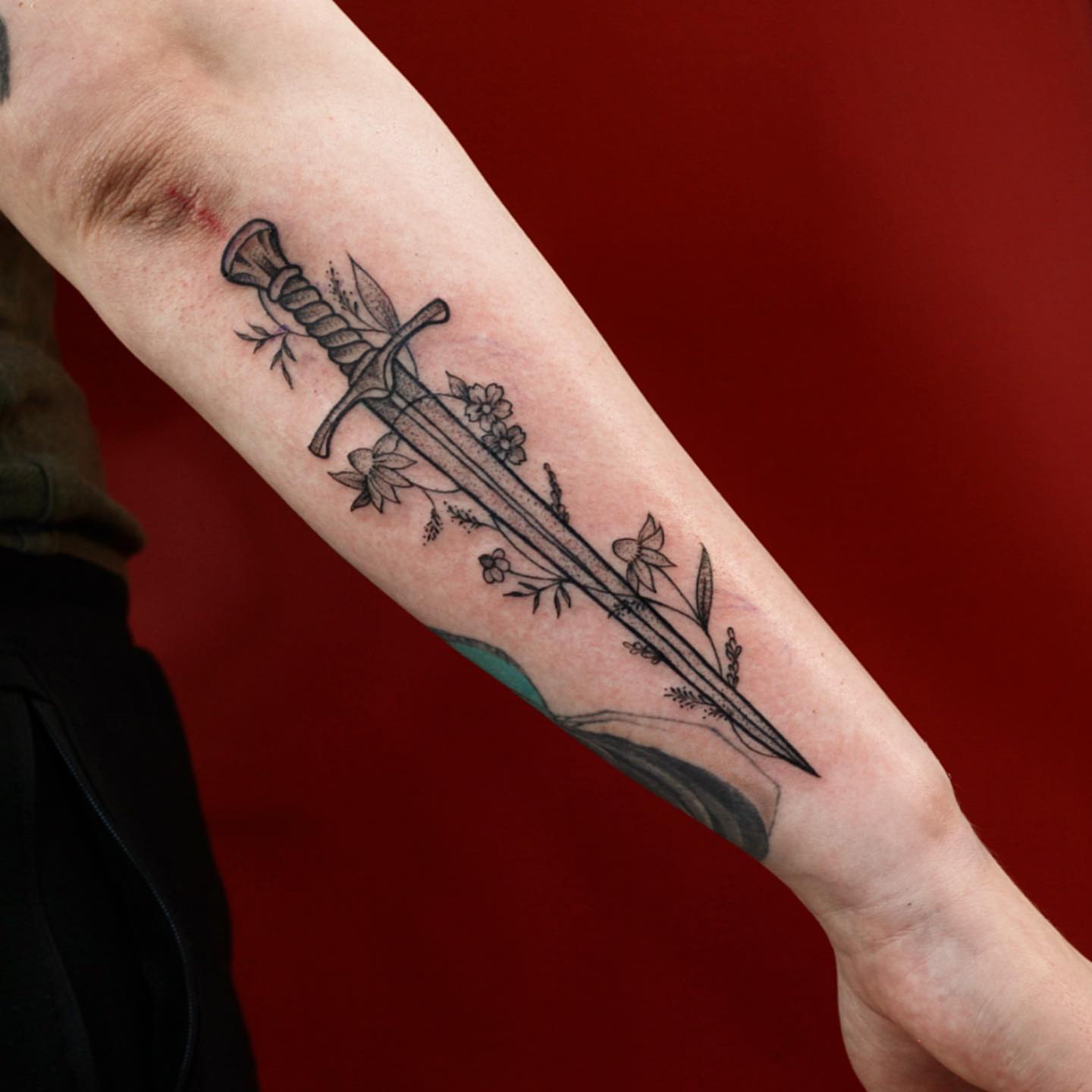 Sword with floral details black and grey tattoo on the forearm by adrienne mae ❀