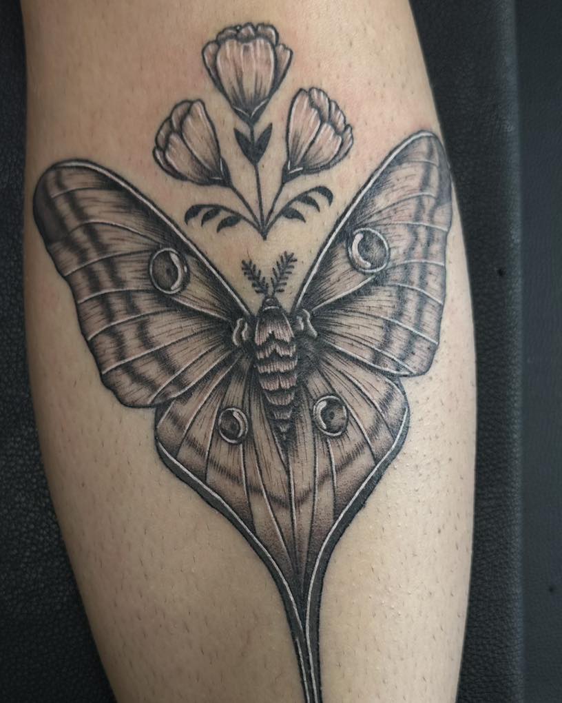 Butterfly and flowers realism tattoo on the forearm by Sarah Nash