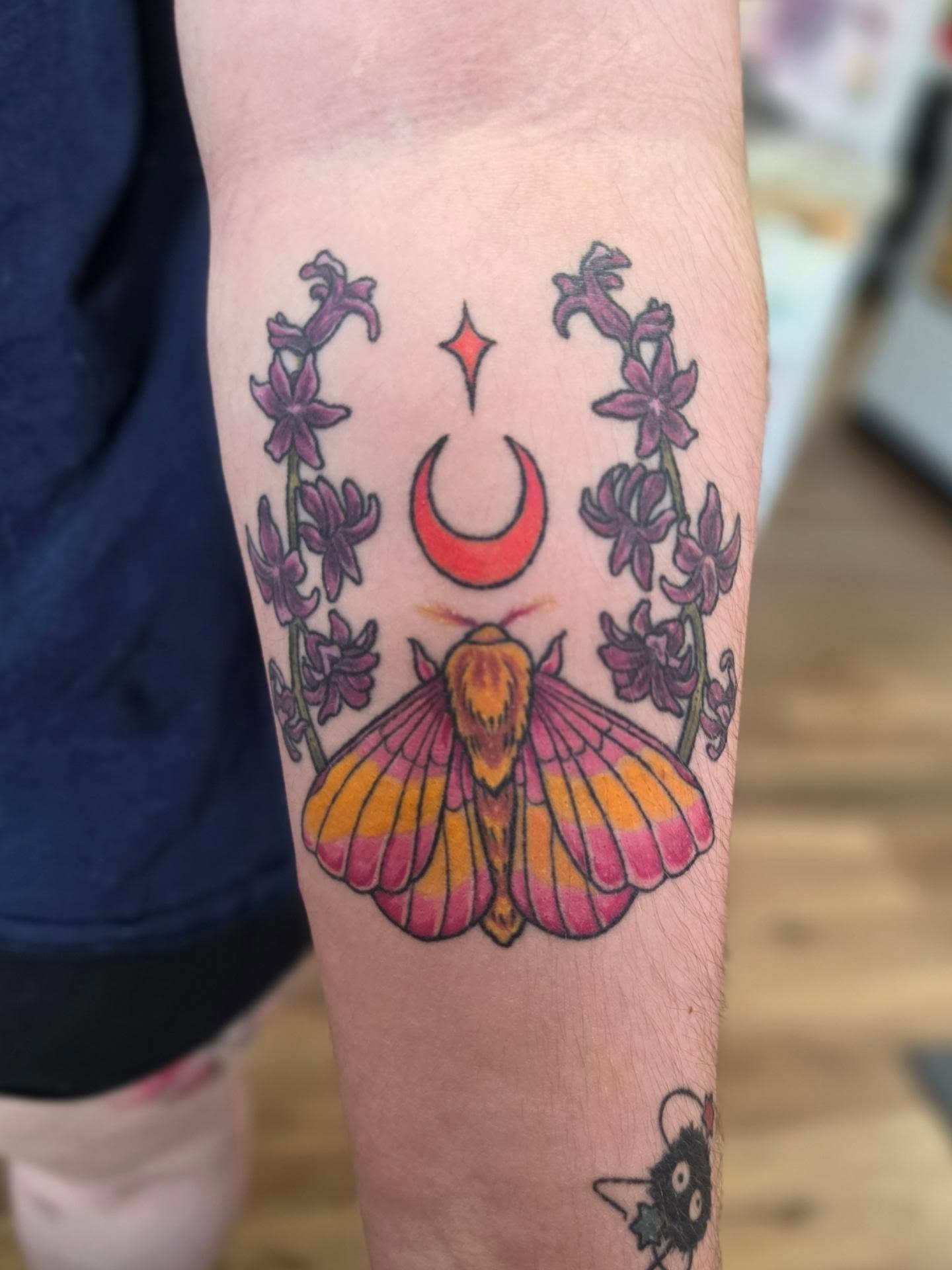 Moth and crescent moon neo-traditional tattoo on the forearm by Colleen