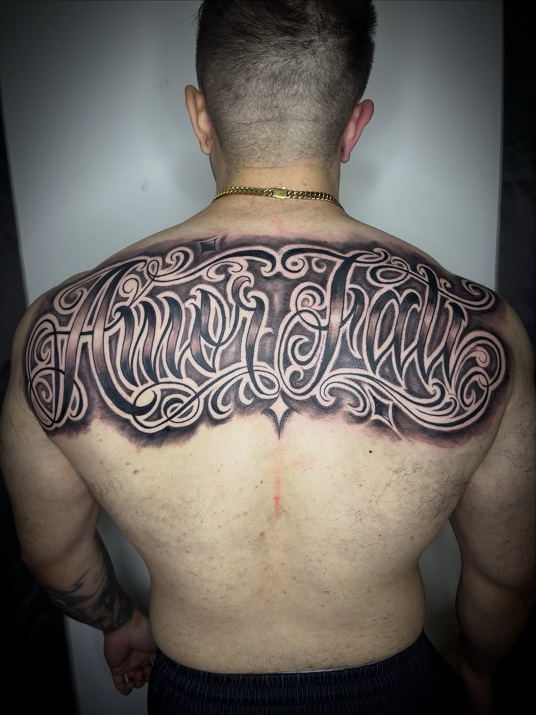 Ornamental script lettering Chicano tattoo on the back by Adrian Ram 🇬🇾🇵🇭